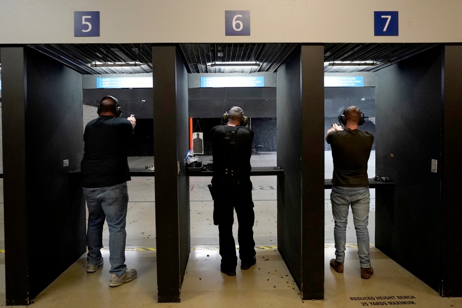 FILE - Gun owners fire their pistols at an indoor shooting range during a qualification course to renew their carry concealed handgun permits, July 1, 2022, at the Placer Sporting Club in Roseville, Calif. A California law that bans people from carrying firearms in most public places is taking effect on New Year's Day, even as a court case continues to challenge the law. (AP Photo/Rich Pedroncelli, File)