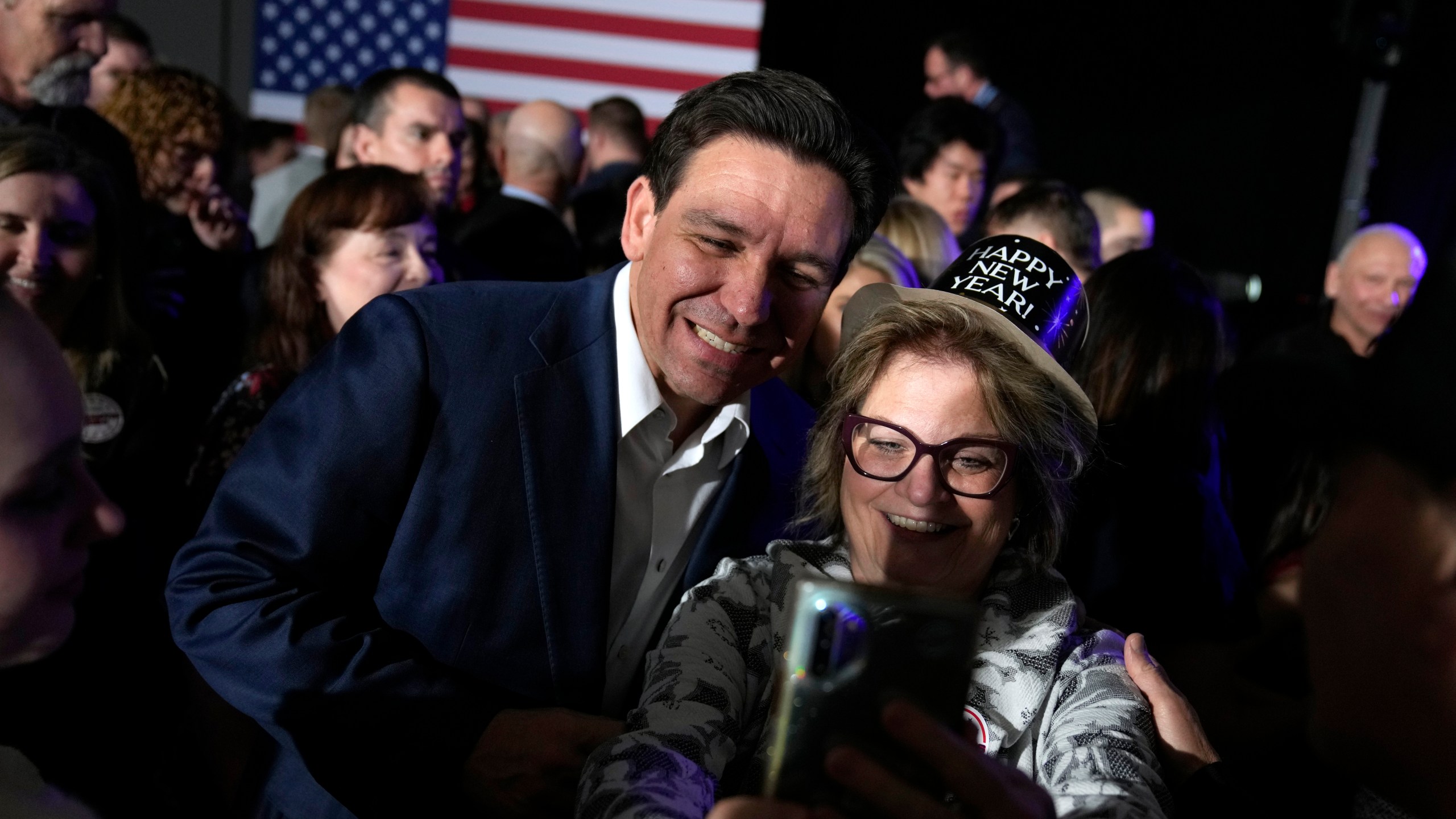 Republican presidential candidate Florida Gov. Ron DeSantis greets audience members during a New Year's Eve campaign event, Sunday, Dec. 31, 2023, in West Des Moines, Iowa. (AP Photo/Charlie Neibergall)