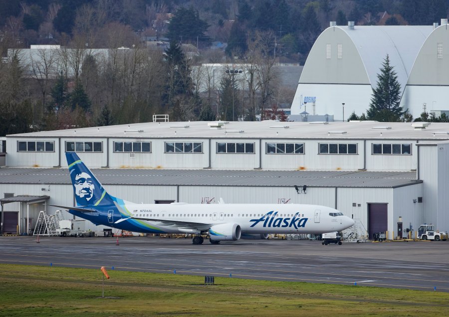 Alaska Airlines N704AL, a 737 Max 9 which made an emergency landing at Portland International Airport after a part of the fuselage broke off mid-flight on Friday, is parked at a maintenance hanger in Portland, Ore., Saturday, Jan. 6, 2024. (AP Photo/Craig Mitchelldyer)