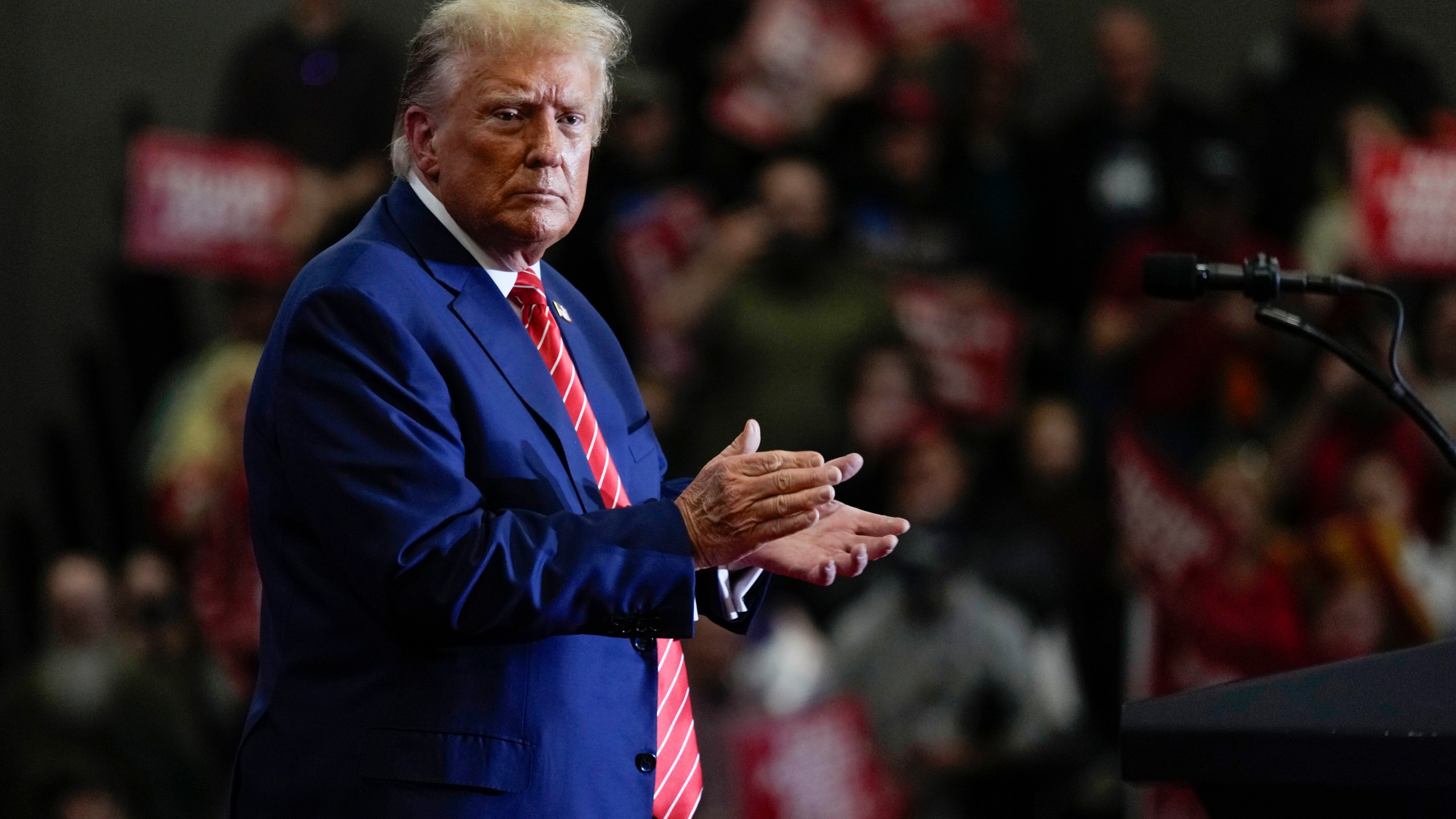 Republican presidential candidate former President Donald Trump stands on stage after speaking during a commit to caucus rally, Saturday, Jan. 6, 2024, in Clinton, Iowa. (AP Photo/Charlie Neibergall)