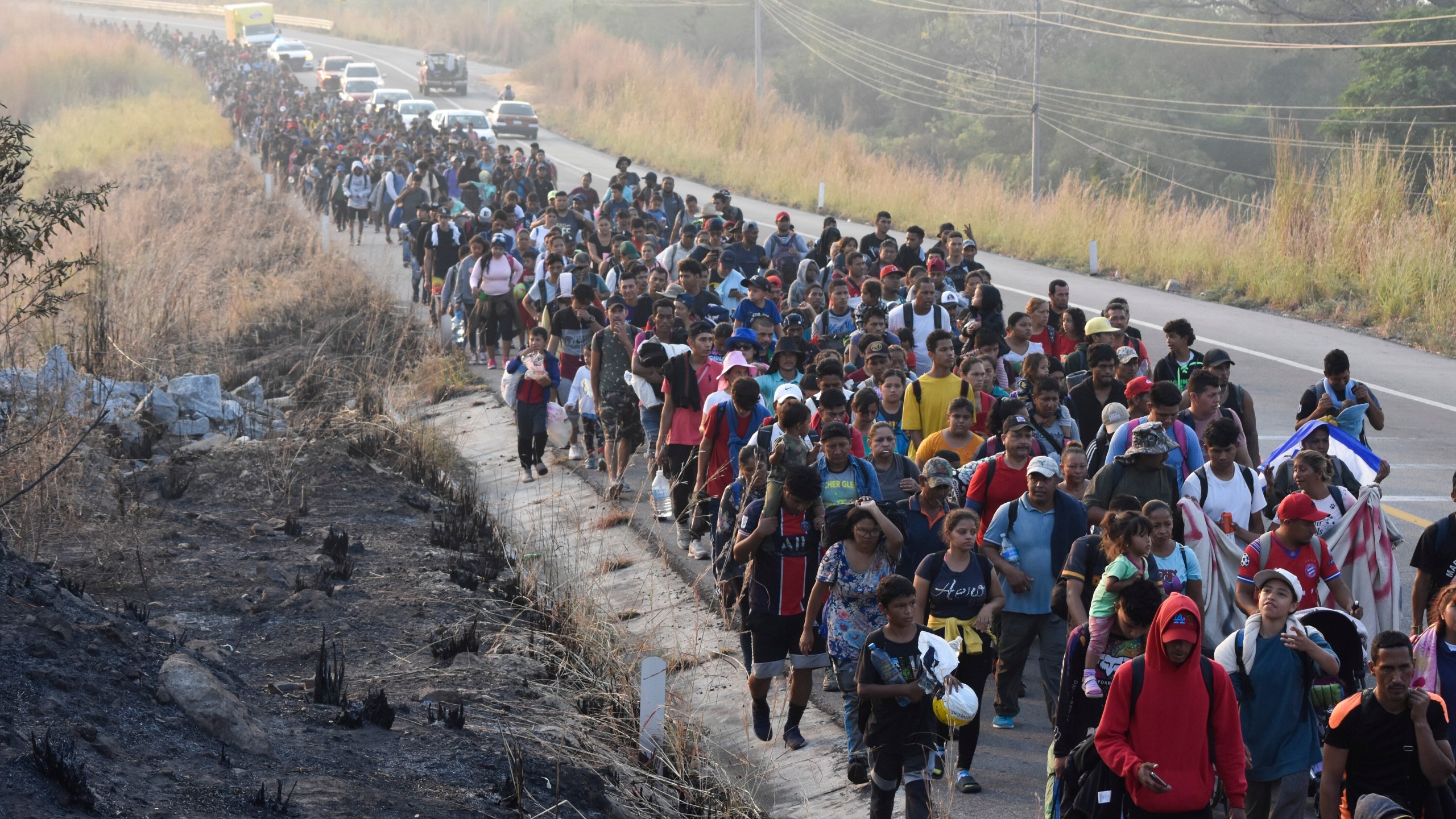 Migrants walk along the highway through Arriaga, Chiapas state in southern Mexico, Monday, Jan. 8, 2024, during their journey north toward the U.S. border. (AP Photo/Edgar H. Clemente)