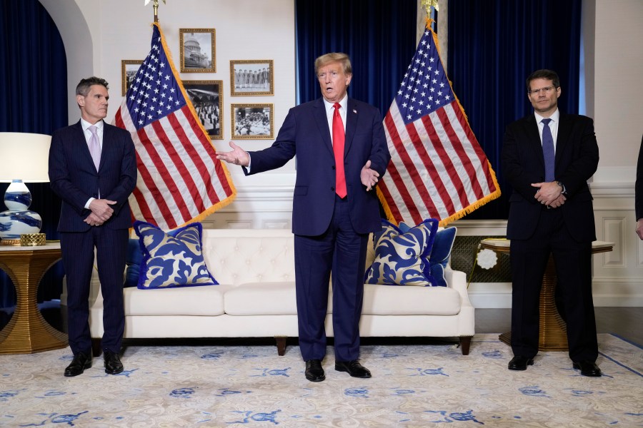 Former President Donald Trump speaks to the media at a Washington hotel, Tuesday, Jan. 9, 2024, after attending a hearing before the D.C. Circuit Court of Appeals at the federal courthouse in Washington, with attorneys John Lauro, left, and D. John Sauer, right. (AP Photo/Susan Walsh)