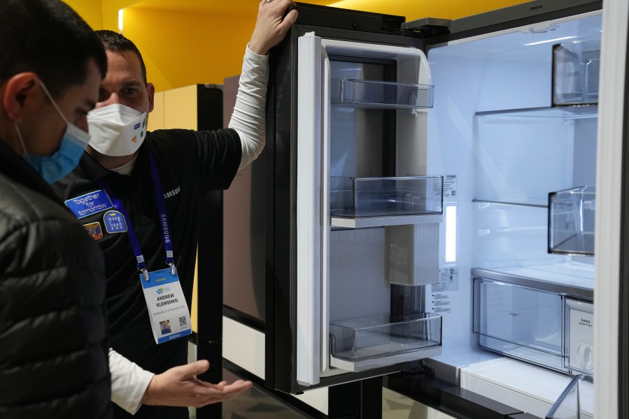 File - Andrew Klemenko shows off a Smart Counter Depth BESPOKE 4-Door Flex refrigerator at the Samsung booth during the CES tech show in Las Vegas. At the dawn of 2024, also known as New Year's resolution season, there are lots of small, easily achievable ways to lead more climate friendly lives. (AP Photo/Joe Buglewicz, File)