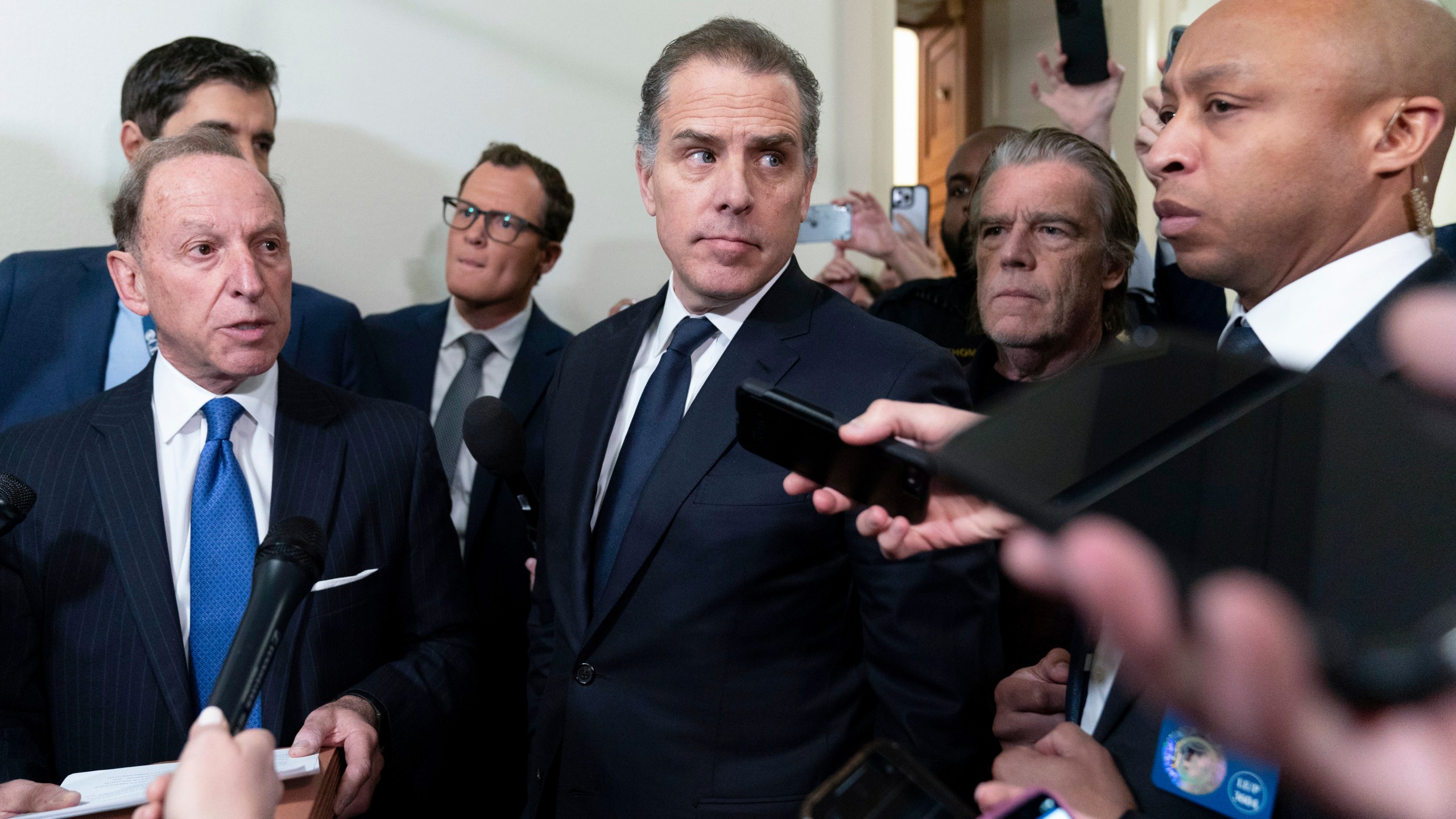 Hunter Biden, President Joe Biden's son, accompanied by his attorney Abbe Lowell, talks to reporters as they leave a House Oversight Committee hearing as Republicans are taking the first step toward holding him in contempt of Congress, Wednesday, Jan. 10, 2024, on Capitol Hill in Washington. (AP Photo/Jose Luis Magana)