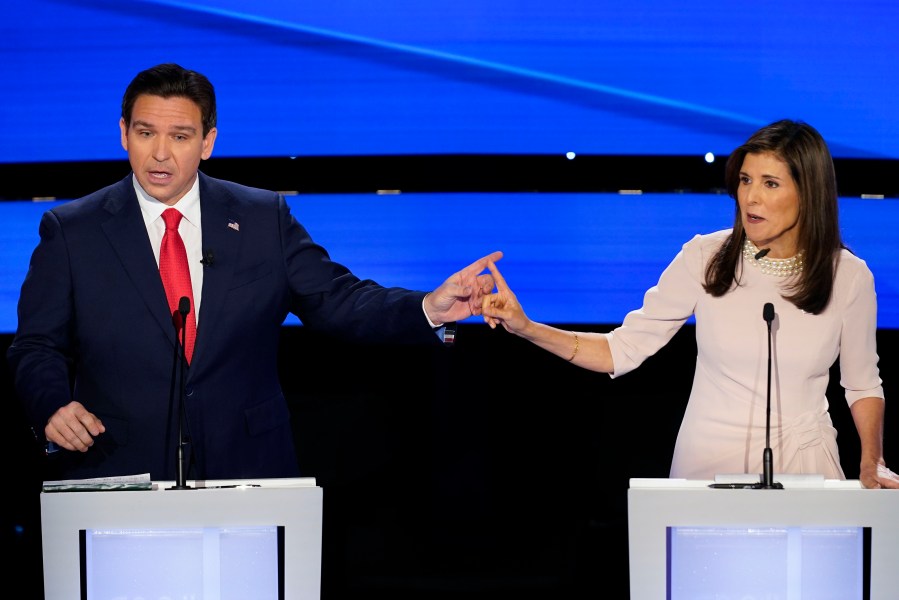 Former UN Ambassador Nikki Haley, right and Florida Gov. Ron DeSantis, left, pointing at each other during the CNN Republican presidential debate at Drake University in Des Moines, Iowa, Wednesday, Jan. 10, 2024. (AP Photo/Andrew Harnik)