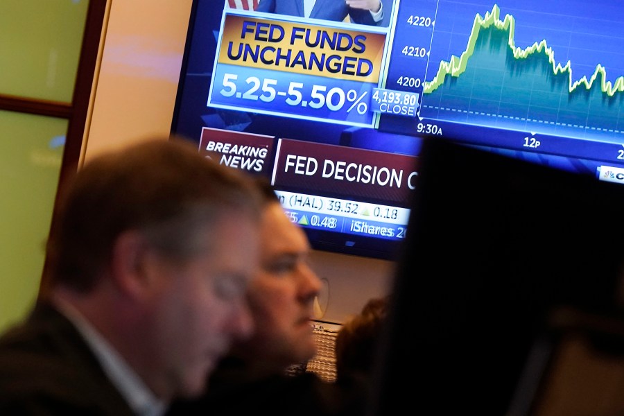 FILE - A television screen shows the rate decision of the Federal Reserve as traders work on the floor of the New York Stock Exchange, Nov. 1, 2023. Inflation has kept slowing, and the economy has withstood the strain of the accumulated higher borrowing costs. On Thursday, Jan. 11, 2024, the Labor Department is expected to report that underlying inflationary pressures eased further in December 2023. (AP Photo/Richard Drew, File)