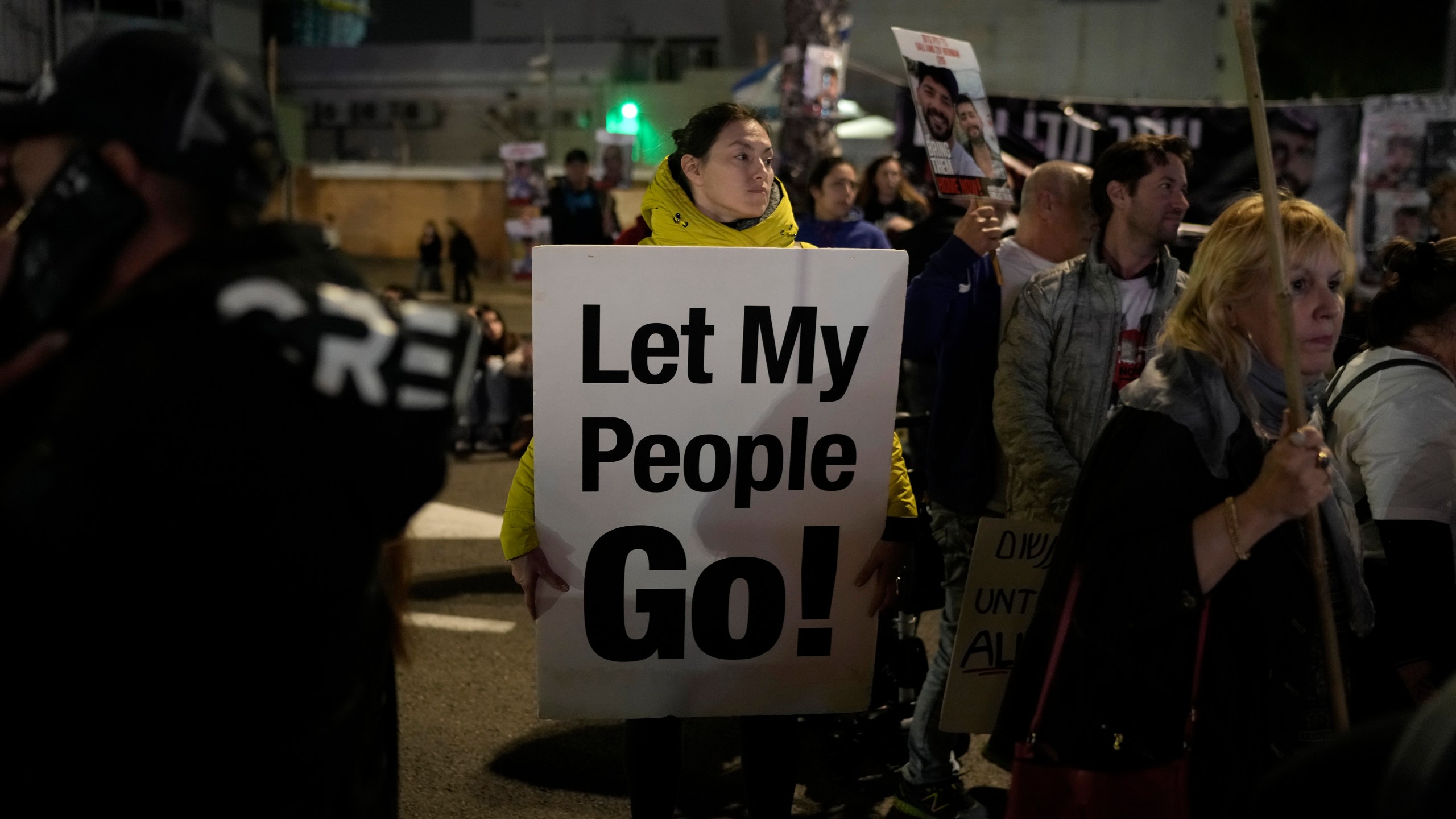 A woman holds a sign calling for the release of the hostages taken by Hamas militants into the Gaza Strip at the Hostages Square in Tel Aviv, Israel, Saturday Jan. 13, 2024. Sunday marks 100 days that Israel and Hamas have been at war after Hamas' cross-border attack on Oct. 7 in which the group killed some 1,200 people, mostly civilians, and took 250 others hostage. In the Gaza Strip, health authorities say the death toll already has eclipsed 23,000 people, roughly 1% of the Palestinian territory's population. Thousands more remain missing or badly wounded.(AP Photo/Leo Correa)