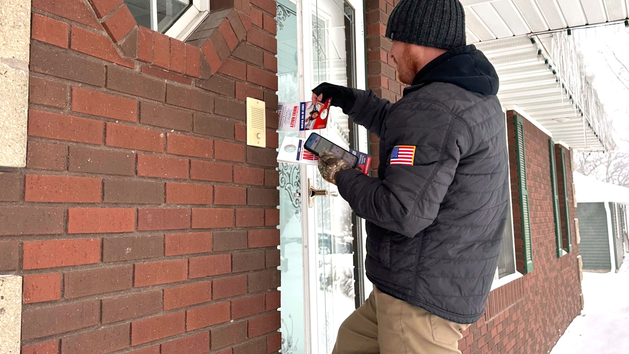 Drew Klein, a senior adviser with AFP Action, a group that has endorsed Nikki Haley, knocks on doors Jan. 13, 2024, in Urbandale, Iowa. Klein was one of more than 200 people working outdoors despite the frigid weather, in the days leading up to the Iowa caucuses to try to persuade undecided voters to support Haley. (AP Photo/Jill Colvin)