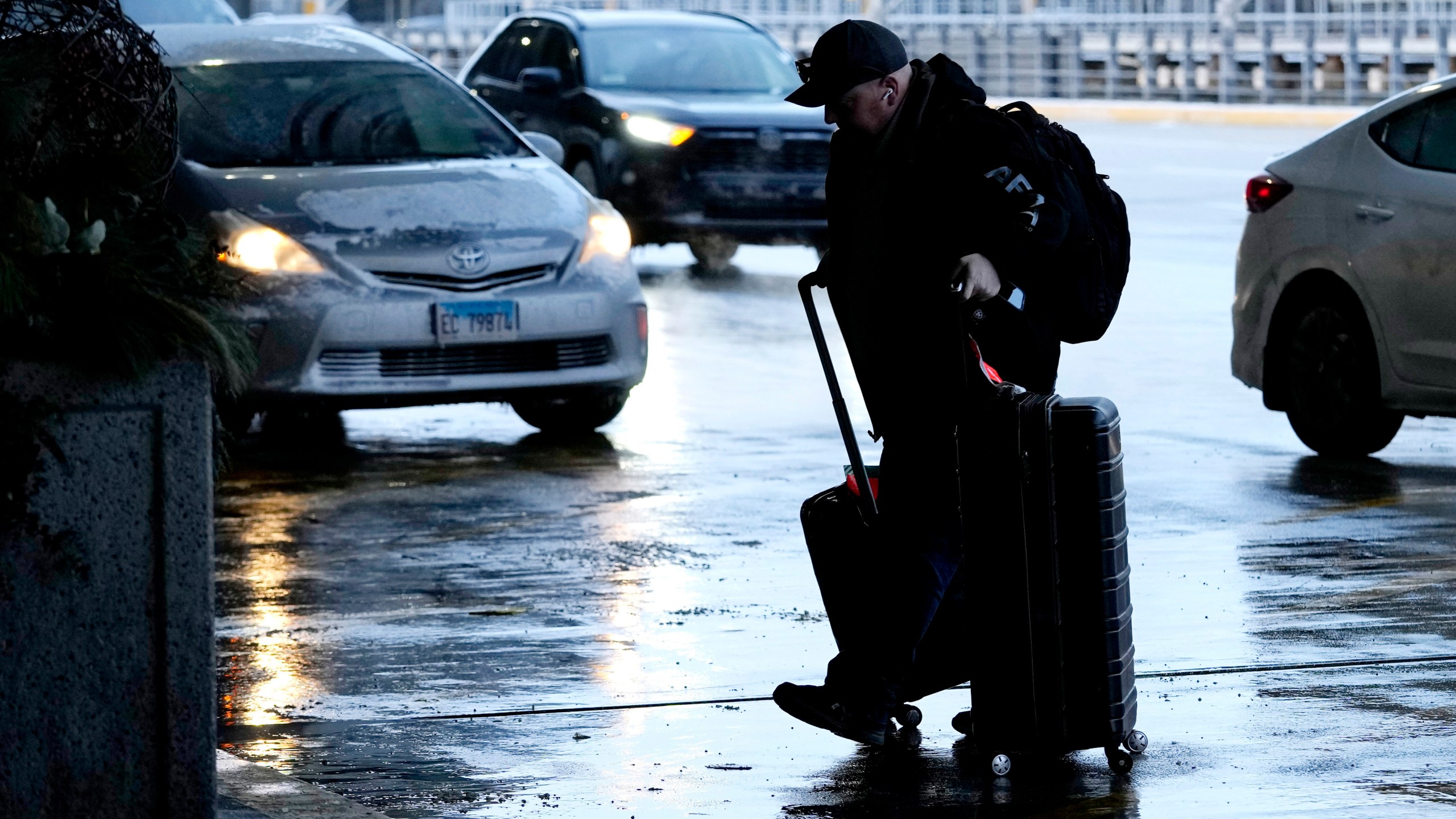 A traveler walks to a ticketing desk at the O'Hare International Airport in Chicago, Sunday, Jan. 14, 2024. Over 70 flight cancellations occurred at Chicago airports Sunday. (AP Photo/Nam Y. Huh)