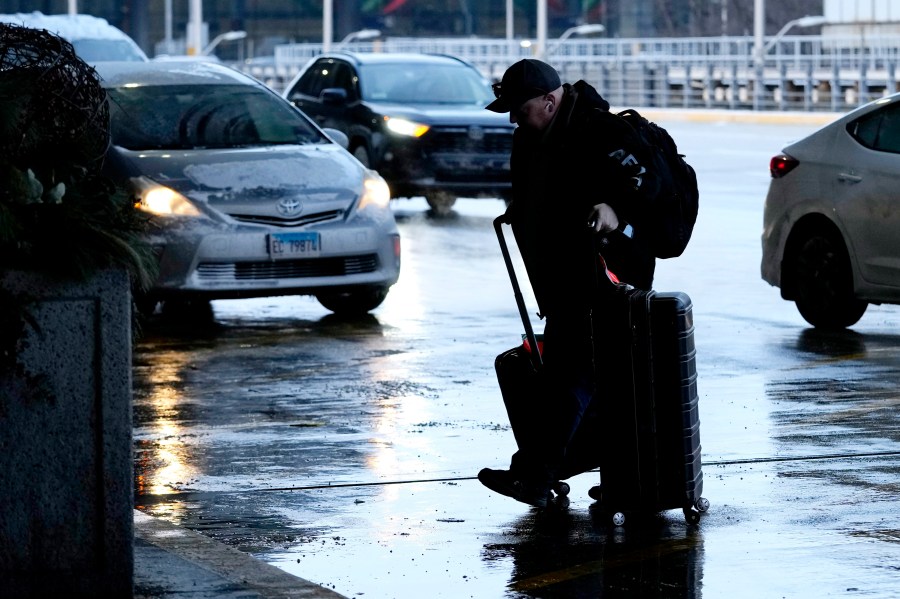 A traveler walks to a ticketing desk at the O'Hare International Airport in Chicago, Sunday, Jan. 14, 2024. Over 70 flight cancellations occurred at Chicago airports Sunday. (AP Photo/Nam Y. Huh)