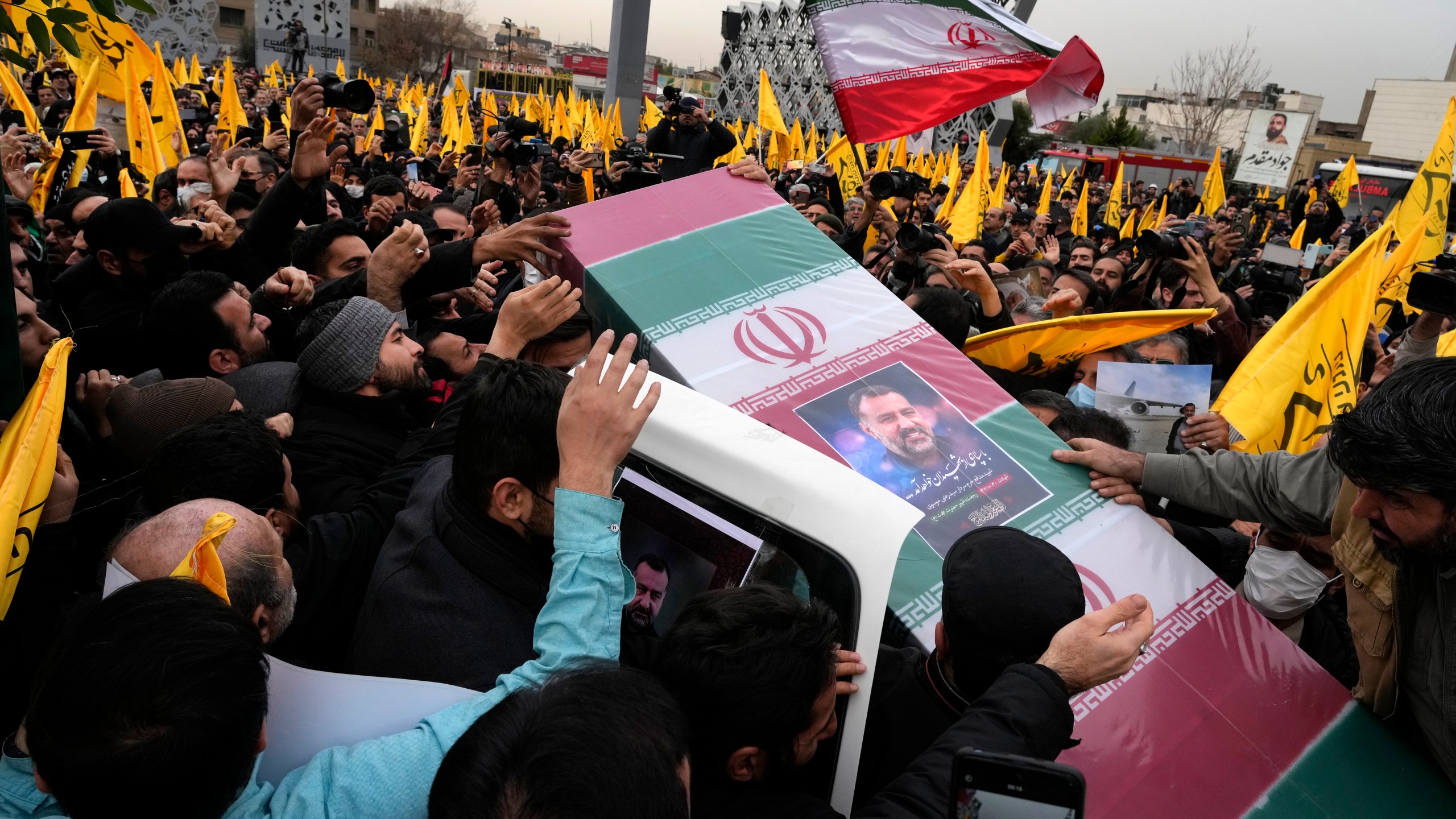 FILE - Iranian mourners carry the flag-draped coffin of Seyed Razi Mousavi, a high ranking Iranian general of the paramilitary Revolutionary Guard, who was killed in an alleged Israeli airstrike in Syria on Monday, during his funeral ceremony in Tehran, Iran, Thursday, Dec. 28, 2023. Iran announced late Monday, Jan. 15, 2024, that it had launched strikes against a “spy headquarters and the gathering of anti-Iranian terrorist groups” shortly after missiles hit an area near the U.S. consulate in Irbil, the seat of Iraq’s semi-autonomous Kurdish region. (AP Photo/Vahid Salemi, File)