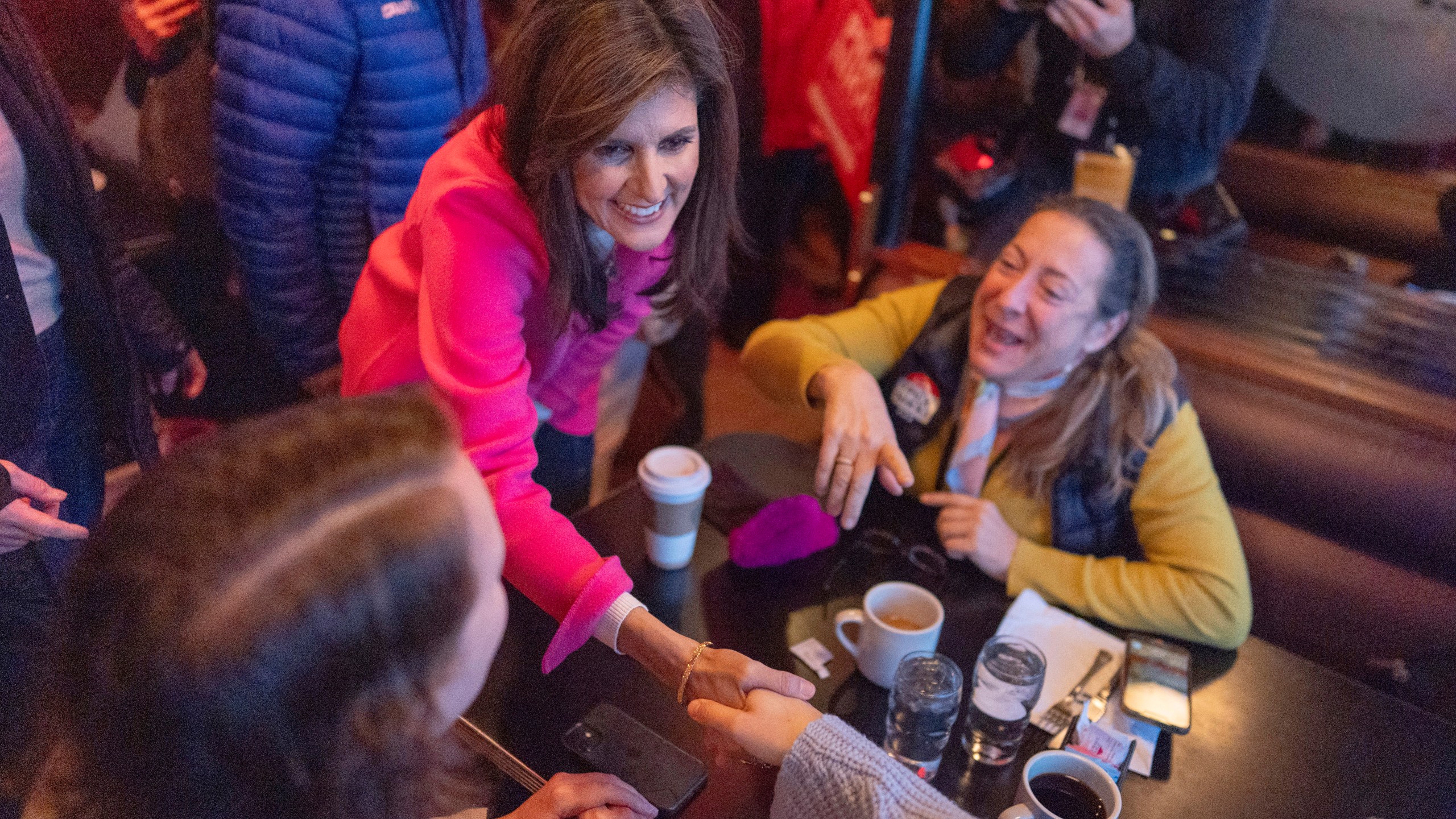 Republican presidential candidate former UN Ambassador Nikki Haley, center, greets supporters during a campaign event at Drake Diner, in Des Moines, Iowa, Monday, Jan. 15, 2024. (AP Photo/Carolyn Kaster)