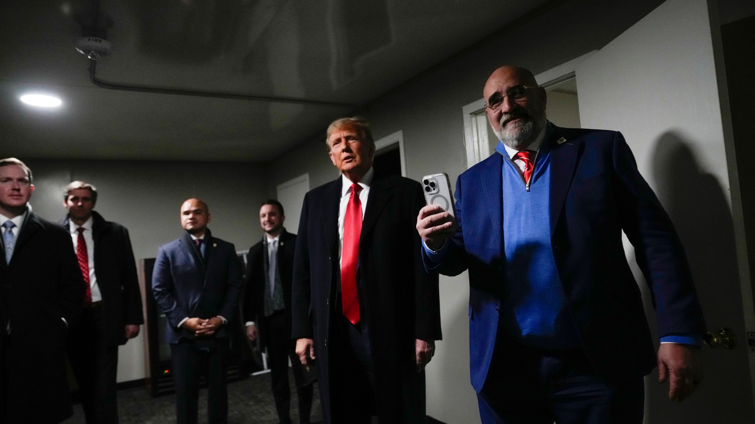 Republican presidential candidate former President Donald Trump stands in a back stage area after speaking at a caucus site at Horizon Events Center, in Clive, Iowa, Monday, Jan. 15, 2024. (AP Photo/Andrew Harnik)