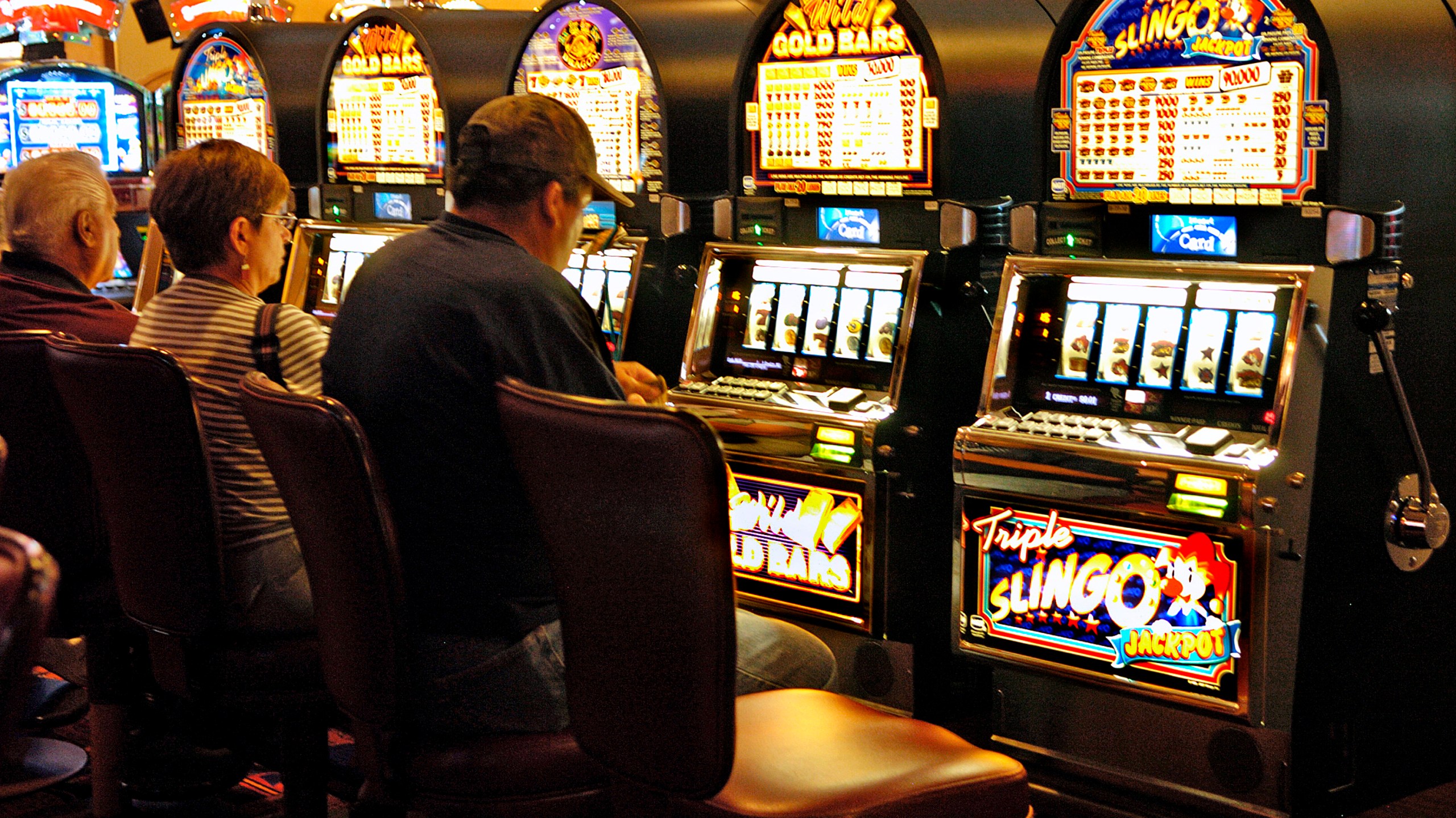 FILE - Customers play the slots at Buffalo Thunder Resort and Casino in Oct. 2008, at the Pojoaque Pueblo, New Mexico. The New Mexico Supreme Court on Tuesday, Jan. 16, 2024, ruled that tribal courts have jurisdiction over personal injury and property damage cases brought against Native American casinos, ending a long battle that saw pueblos and other tribes advocate for protecting sovereignty when such legal claims arise. (Clyde Mueller/Santa Fe New Mexican via AP, File)