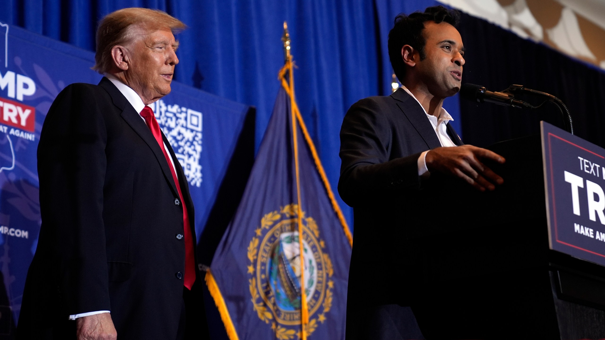 Republican presidential candidate former President Donald Trump listens as former candidate Vivek Ramaswamy speaks at a campaign event in Atkinson, N.H., Tuesday, Jan. 16, 2024. (AP Photo/Matt Rourke)