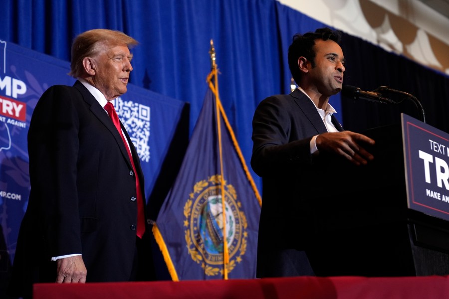 Republican presidential candidate former President Donald Trump listens as former candidate Vivek Ramaswamy speaks at a campaign event in Atkinson, N.H., Tuesday, Jan. 16, 2024. (AP Photo/Matt Rourke)