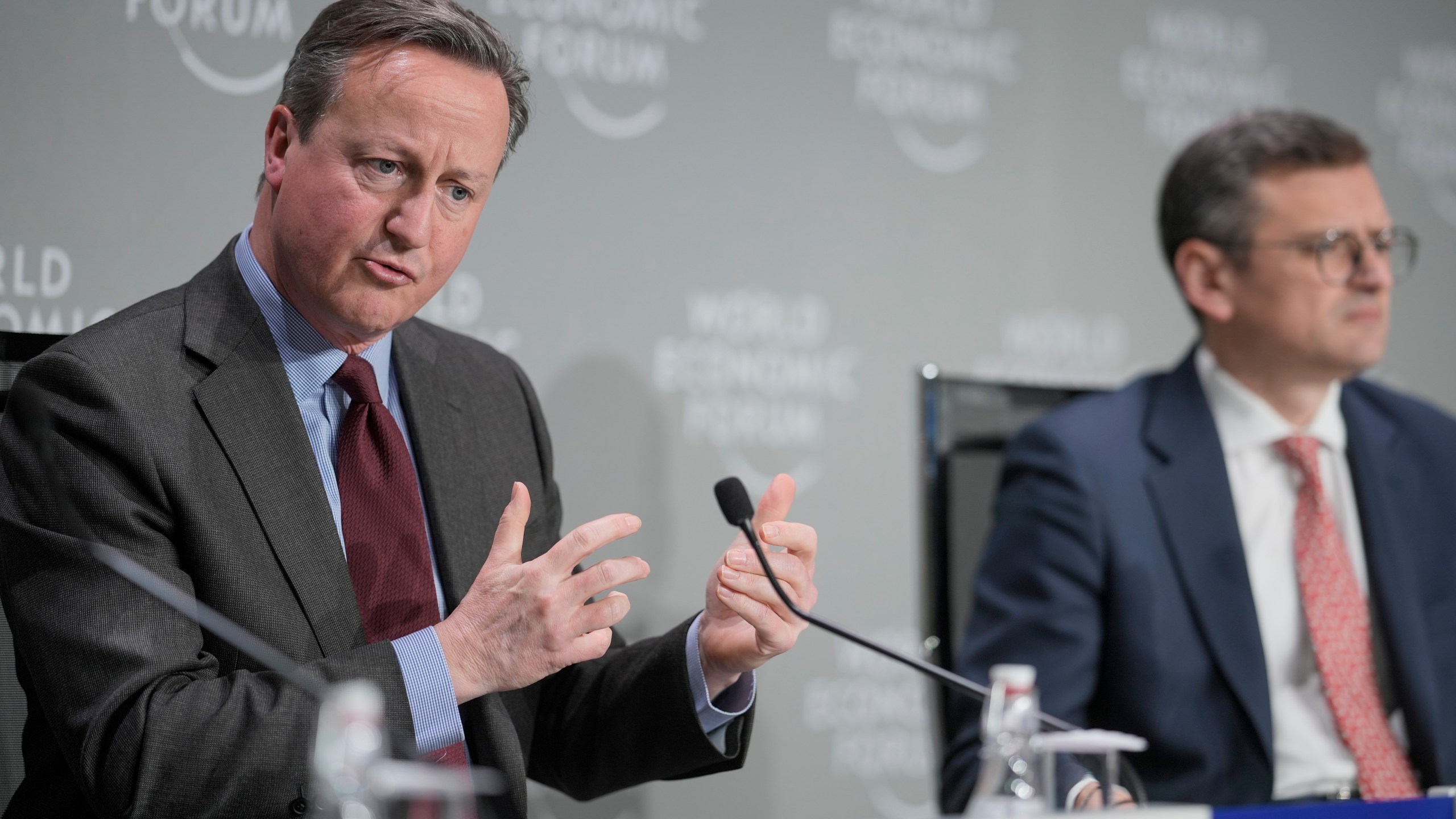 Britain's Foreign Secretary David Cameron, left, and Ukraine's Foreign Minister Dmytro Kuleba take part in a panel discussion at the Annual Meeting of World Economic Forum in Davos, Switzerland, Wednesday, Jan. 17, 2024. The annual meeting of the World Economic Forum is taking place in Davos from Jan. 15 until Jan. 19, 2024.(AP Photo/Markus Schreiber)