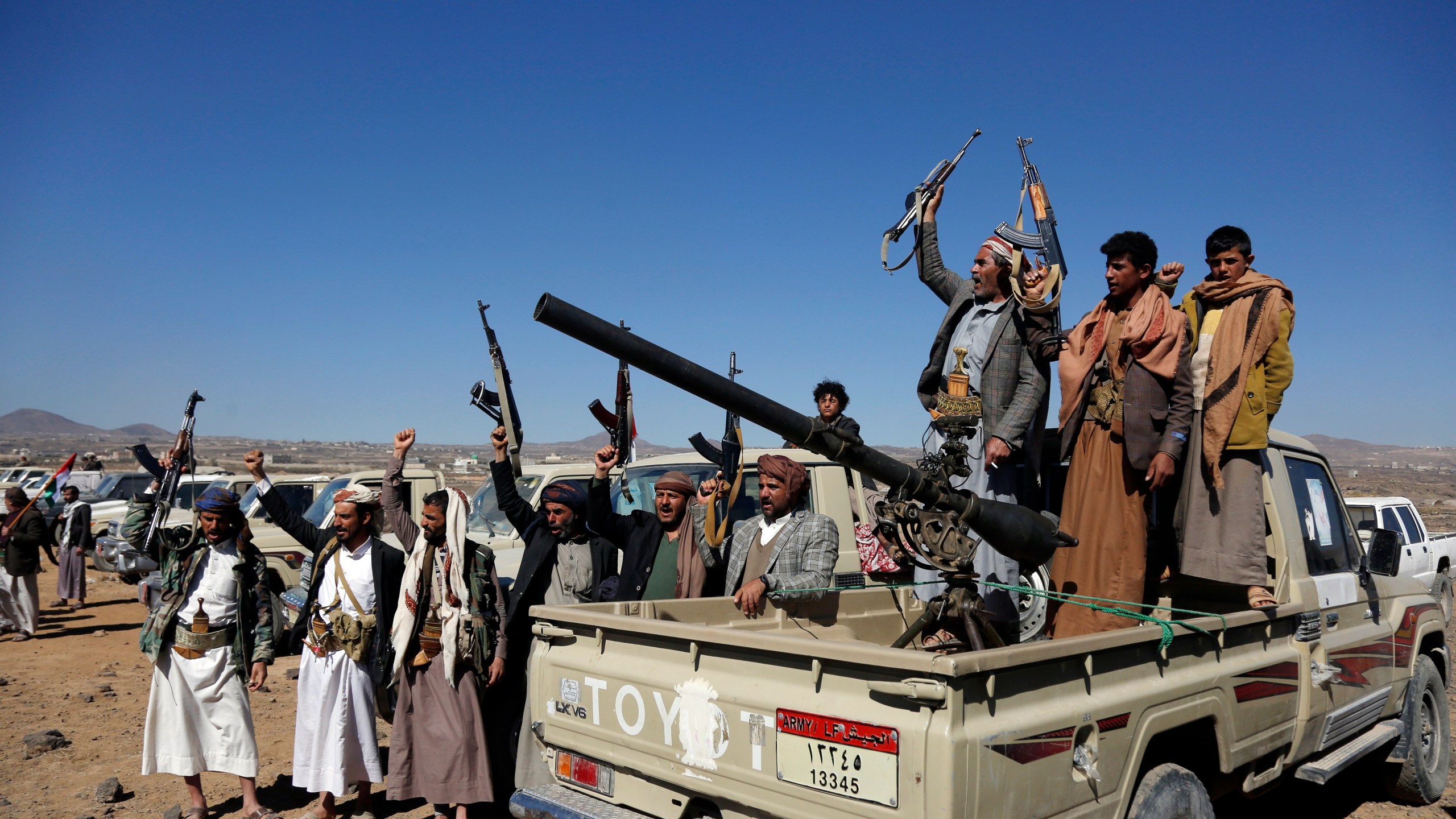 Houthi fighters and tribesmen stage a rally against the U.S. and the U.K. strikes on Houthi-run military sites near Sanaa, Yemen, on Sunday, Jan. 14, 2024. (AP Photo)
