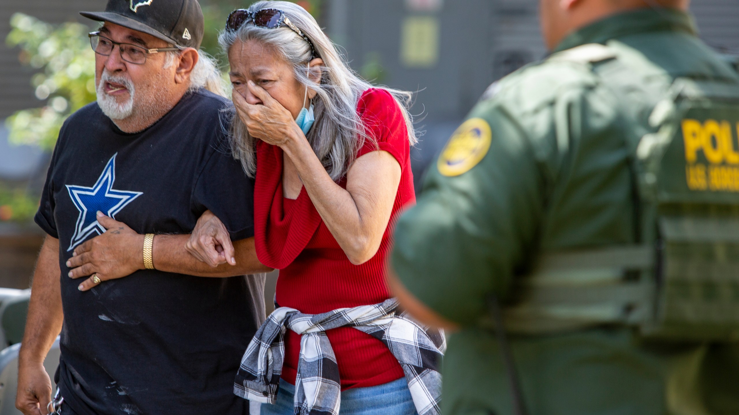 FILE - A woman cries as she leaves the Uvalde Civic Center, Tuesday May 24, 2022, in Uvalde, Texas, after a mass shooting. AA federal report into the halting and haphazard law enforcement response to a school shooting in Uvalde, Texas, was scheduled to be released Thursday, Jan. 18, 2024, reviving scrutiny of the hundreds of officers who responded to the 2022 massacre but waited more than an hour to confront and kill the gunman. (William Luther/The San Antonio Express-News via AP, File)