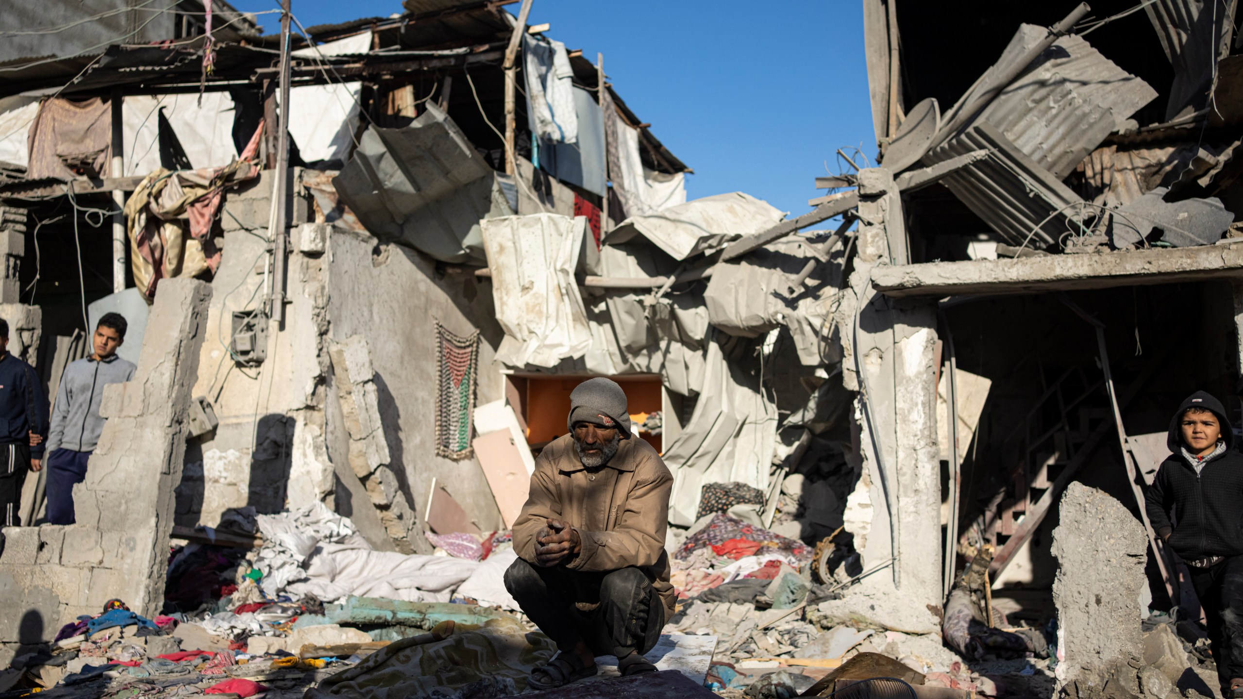 Palestinians look at the destruction after an Israeli strike in Rafah, southern Gaza Strip, Thursday, Jan. 18, 2024. (AP Photo/Fatima Shbair)