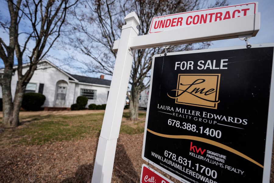 A sign indicating that a home is under contract is shown on Tuesday, Jan. 16, 2024, in Kennesaw, Ga. On Friday, the National Association of Realtors reports on existing home sales for December. (AP Photo/Mike Stewart)