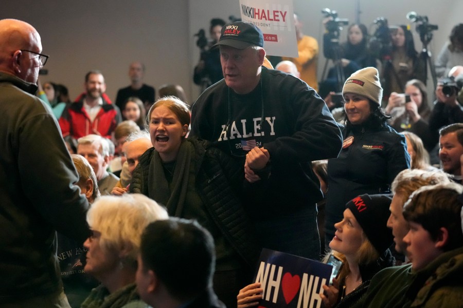 A climate protester is removed by security at a rally held by Republican presidential candidate former U.N. Ambassador Nikki Haley, Saturday, Jan. 20, 2024, in Nashua, N.H. (AP Photo/Robert F. Bukaty)