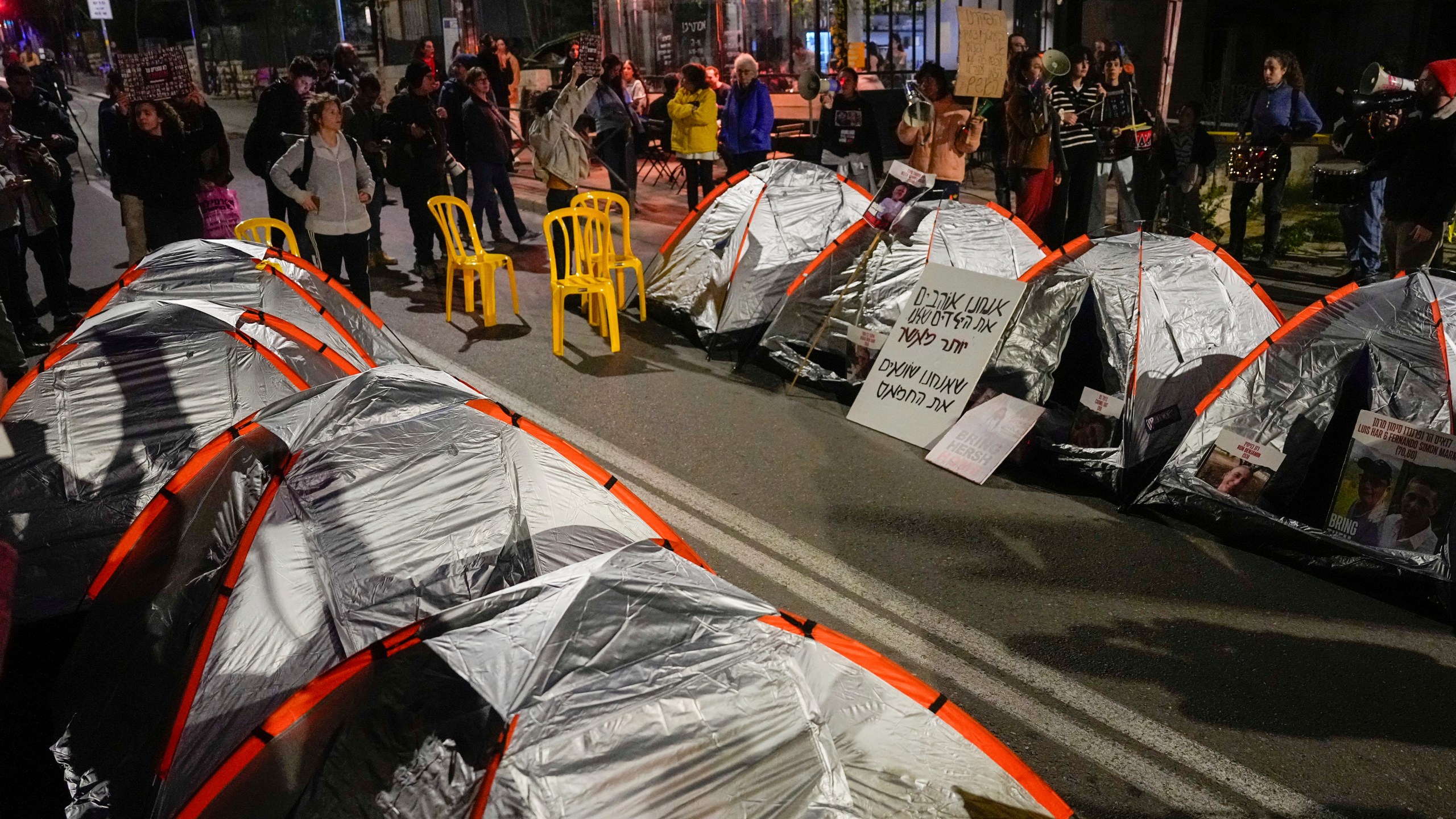 Relatives and supporters of the Israeli hostages held in the Gaza Strip by the Hamas militant group block a road with tents during a protest calling for their release outside Israeli Prime Minister Benjamin Netanyahu's residence, in Jerusalem, Sunday, Jan. 21, 2024. (AP Photo/Ohad Zwigenberg)