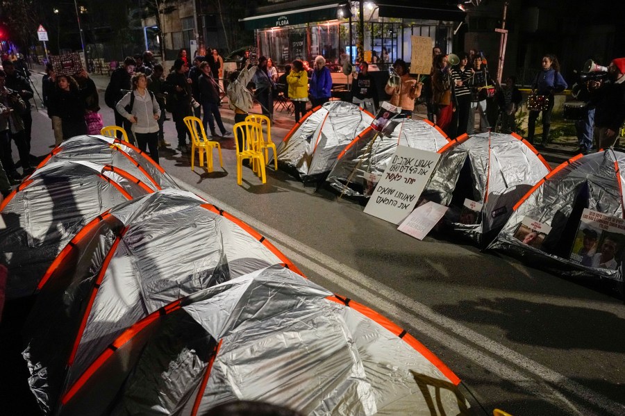 Relatives and supporters of the Israeli hostages held in the Gaza Strip by the Hamas militant group block a road with tents during a protest calling for their release outside Israeli Prime Minister Benjamin Netanyahu's residence, in Jerusalem, Sunday, Jan. 21, 2024. (AP Photo/Ohad Zwigenberg)