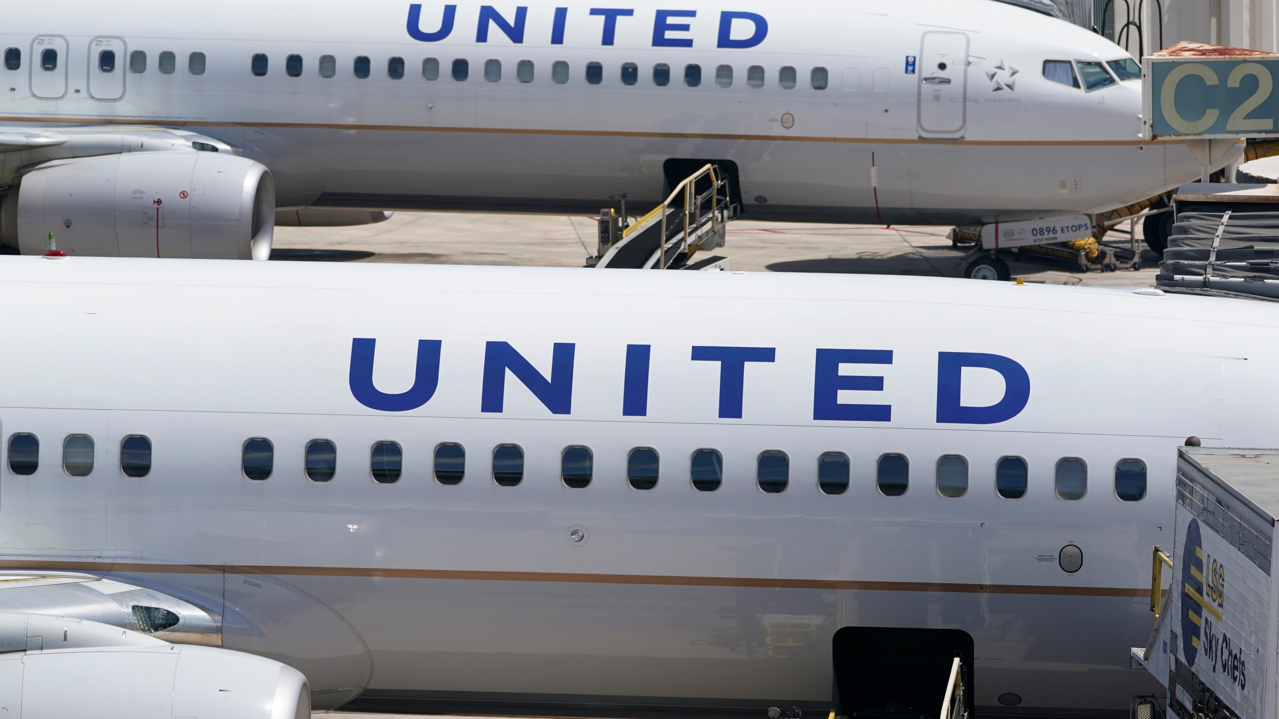Two United Airlines Boeing 737s are parked at the gate at the Fort Lauderdale-Hollywood International Airport in Fort Lauderdale, Fla., on July 7, 2022. United Airlines said Monday, Jan. 22, 2024, it will lose money in the first three months of this year because of the grounding of its Boeing 737 Max 9 planes after a panel blew out of a Max jetliner this month. (AP Photo/Wilfredo Lee)