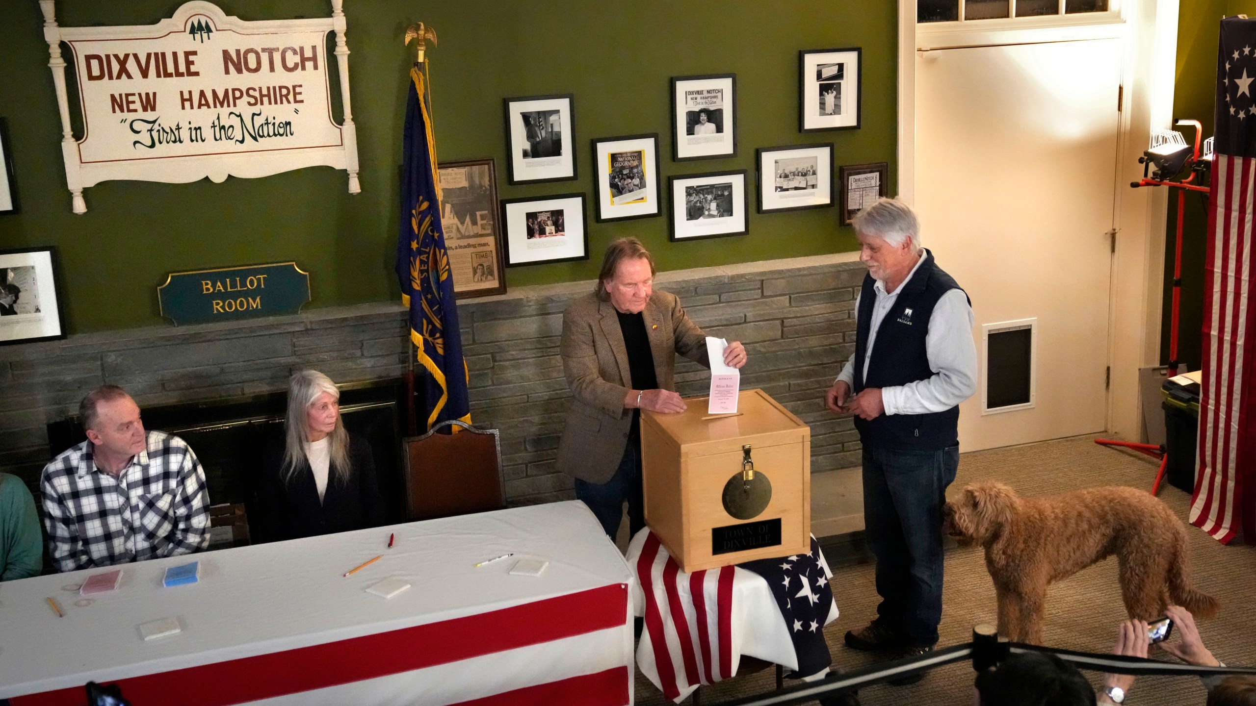 Les Otten, far right, has his vote inserted into the ballot box by town moderator Tom Tillotson shortly after midnight in the presidential primary election, Tuesday, Jan. 23, 2024, in Dixville Notch, N.H. All six voters selected Nikki Haley. (AP Photo/Robert F. Bukaty)