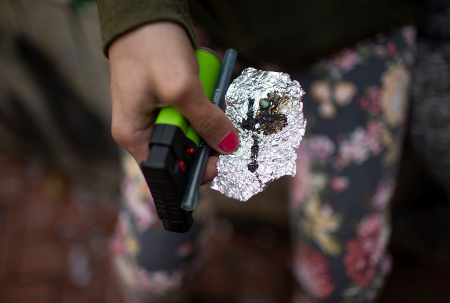 FILE - A person holds drug paraphernalia near the Washington Center building on SW Washington Street, April 4, 2023, in downtown Portland, Ore. On Tuesday, Jan. 23, 2024, Democratic lawmakers in Oregon unveiled a sweeping new bill that would undo a key part of the state's first-in-the-nation drug decriminalization law. The bill would recriminalize the possession of small amounts of drugs as a low-level misdemeanor. (Dave Killen/The Oregonian via AP, File)