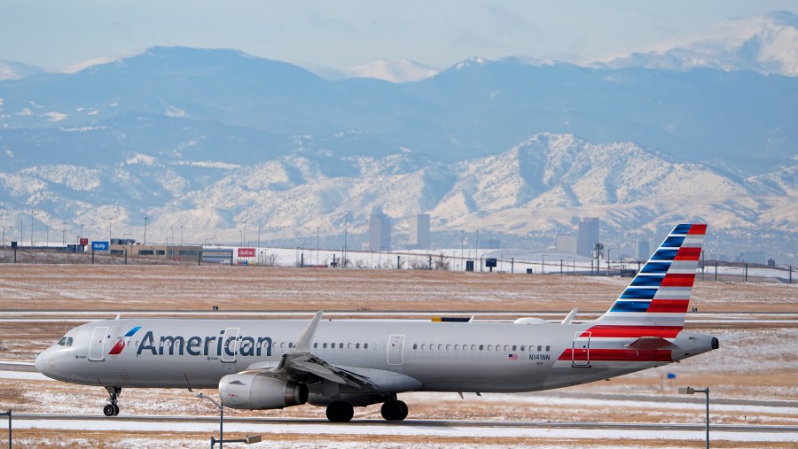 FILE - An American Airlines jetliner rumbles down a runway for take off from Denver International Airport after a winter storm swept through the region Tuesday, Jan. 16, 2024, in Denver. American Airlines reports their earnings on Thursday, Jan. 25, 2024. (AP Photo/David Zalubowski, File)