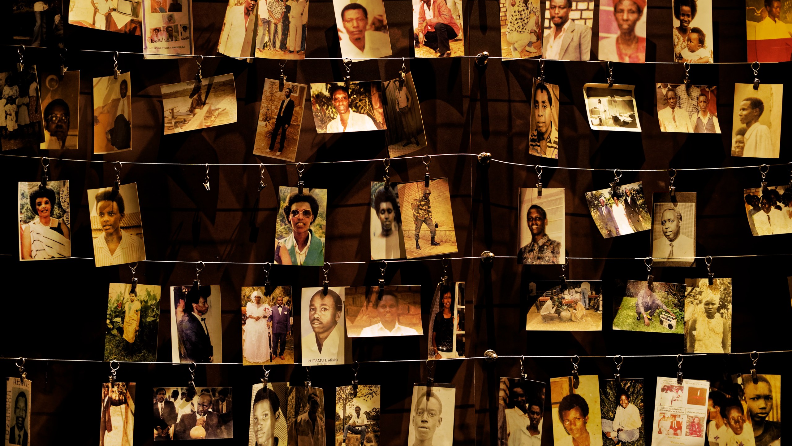 FILE - Family photographs of some of those who died hang on display in an exhibition at the Kigali Genocide Memorial centre in the capital Kigali, Rwanda Friday, April 5, 2019. (AP Photo/Ben Curtis, File)
