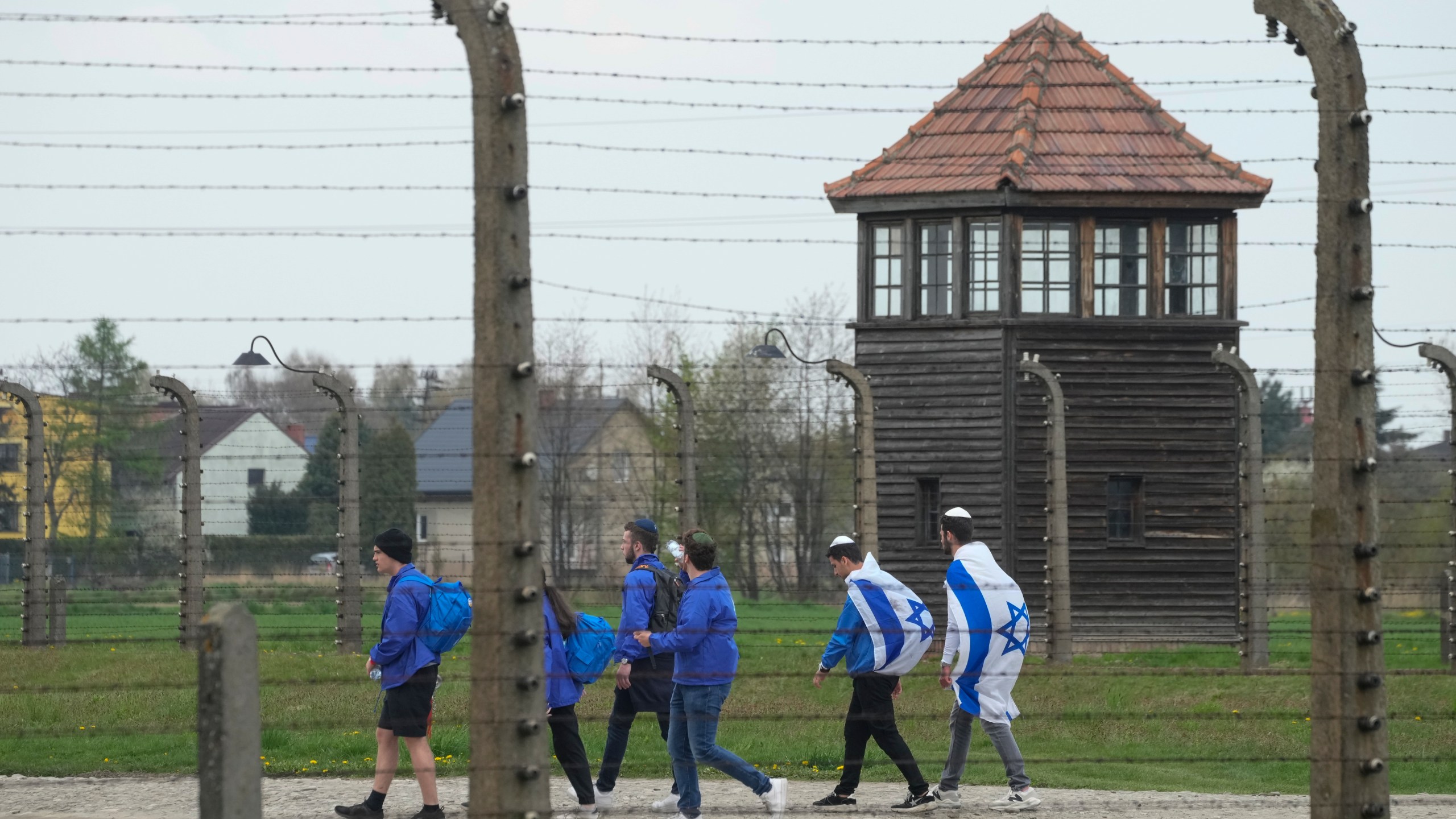 FILE - Jewish people visit the Auschwitz Nazi concentration camp after the March of the Living annual observance, in Oswiecim, Poland, April 28, 2022. Israel's national Holocaust memorial has criticized a new agreement renewing Israeli school trips to Poland, saying it recommends a number of "problematic sites" that distort history. (AP Photo/Czarek Sokolowski, File)