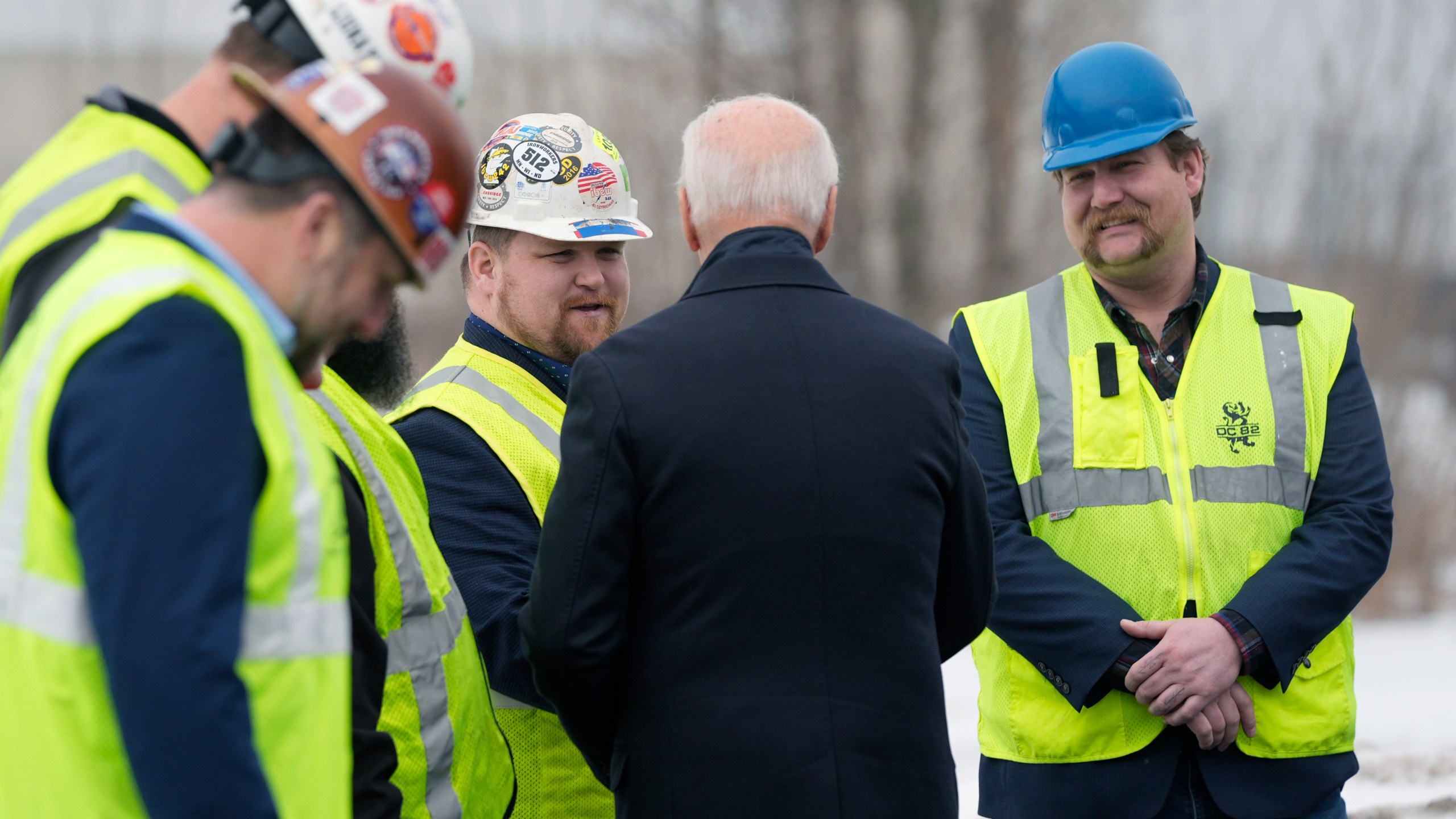 President Joe Biden speaks with iron workers near the John A. Blatnik Bridge between Duluth, Minn., and Superior, Wis., Thursday, Jan. 25, 2024, in Superior, Wis. Biden is returning to the swing state of Wisconsin to announce $5 billion in federal funding for upgrading the Blatnik Bridge and for dozens of similar infrastructure projects nationwide. (AP Photo/Alex Brandon)