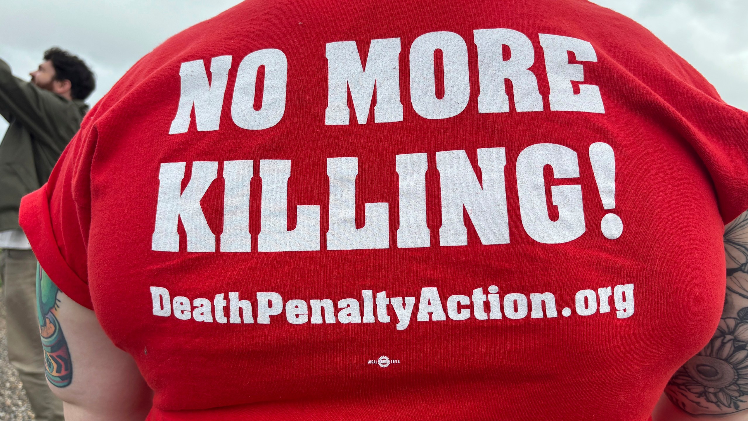 Anti-death penalty activists place signs along the road heading to Holman Correctional Facility in Atmore, Alabama.