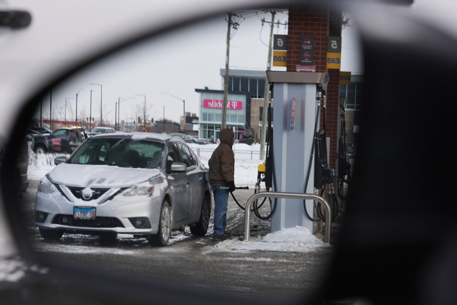 A customer pumps fuel at a gas station in Riverwoods, Ill., Friday, Jan. 19, 2024. On Friday, the Commerce Department issues its December report on consumer spending. (AP Photo/Nam Y. Huh)