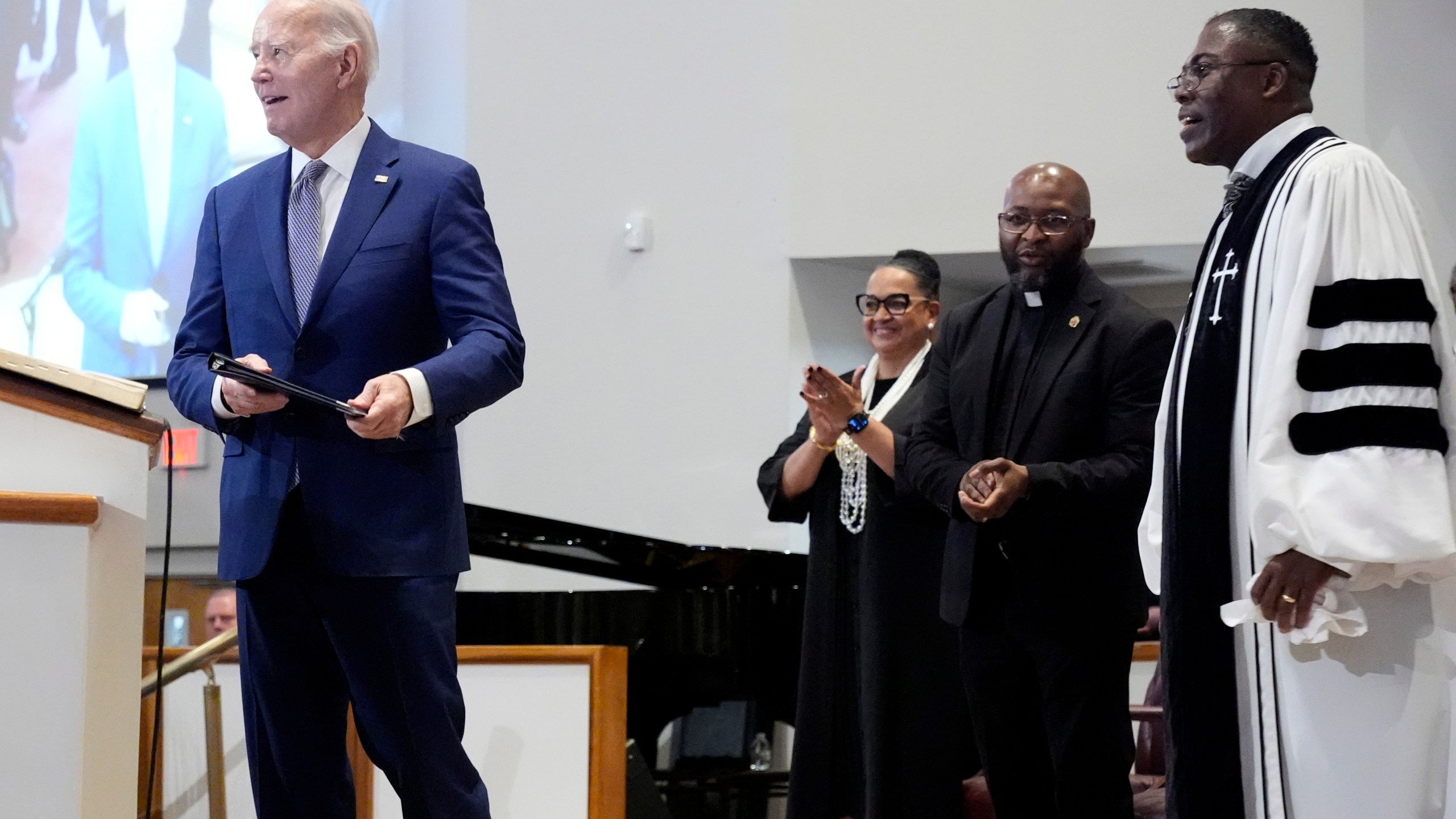 Reverend Dr. Jamey O. Graham Sr., right, looks on as President Joe Biden speaks at St. John Baptist Church in Columbia, S.C., on Sunday, Jan. 28, 2024. (AP Photo/Jacquelyn Martin)