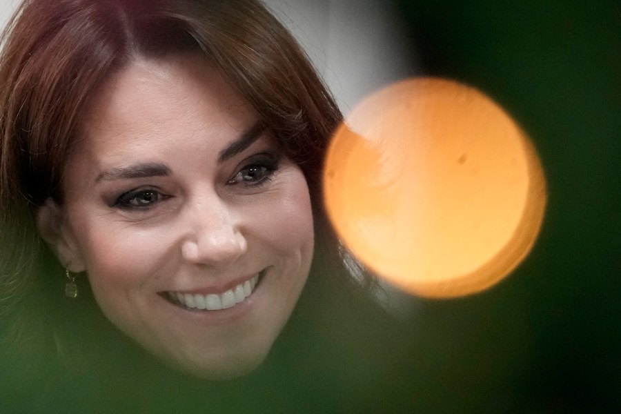 FILE - Kate, Princess of Wales, is seen behind a Christmas tree decorations as talks to people during her visit to Sebby's Corner in north London, Friday, Nov. 24, 2023. Kate, Princess of Wales, has been discharged Monday, Jan. 29, 2024 from a London hospital and is making "good progress" after abdominal surgery. (AP Photo/Frank Augstein, Pool)