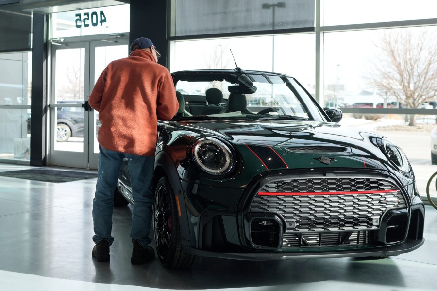 File - A customer looks over an unsold 2024 Cooper S John Cooper Works convertible on the showroom floor of a Mini dealership on Nov. 30, 2023, in Loveland, Colo. On Tuesday, Jan. 30, 2024, the Conference Board reports on U.S. consumer confidence for January. (AP Photo/David Zalubowski, File)