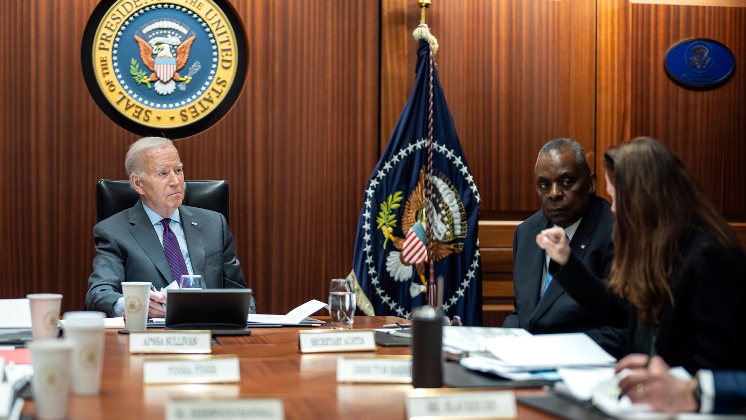 In this image provided by The White House, President Joe Biden receives the Presidential Daily Briefing, Monday, Jan. 29, 2024, in the White House Situation Room at the White House in Washington, as Defense Secretary Lloyd Austin listens. (Adam Schultz/The White House via AP)