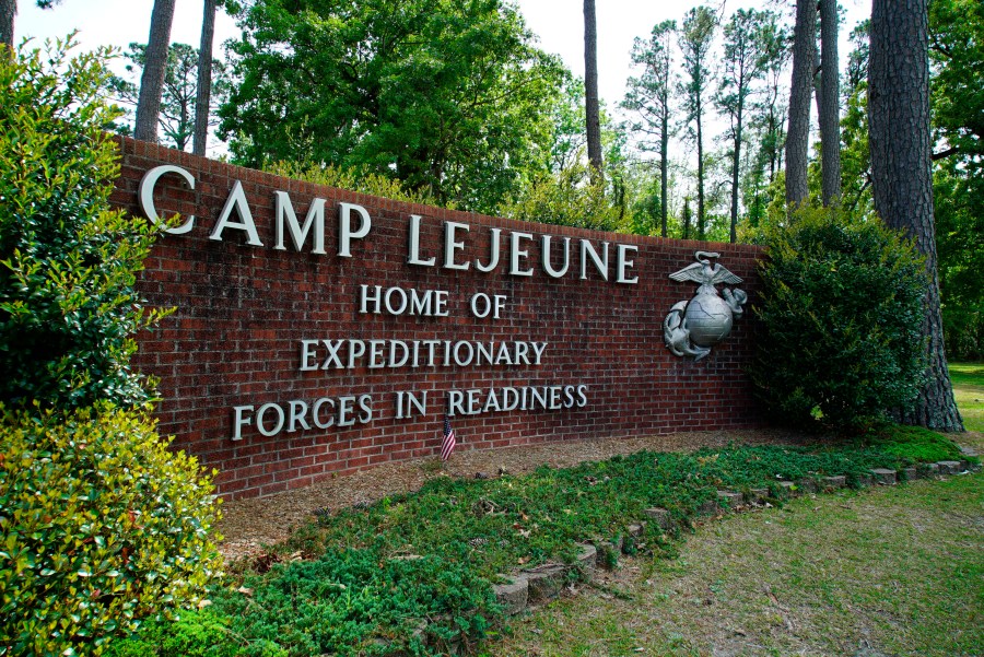 FILE - Signage stands on the main gate to Camp Lejeune Marine Base outside Jacksonville, N.C., April 29, 2022. Military personnel stationed at Camp Lejeune from 1975 to 1985 had at least a 20% higher risk for a number of cancers than those stationed elsewhere, federal health officials said Wednesday, Jan. 31, 2024 in a long-awaited study of the North Carolina base's contaminated drinking water. (AP Photo/Allen G. Breed, File)