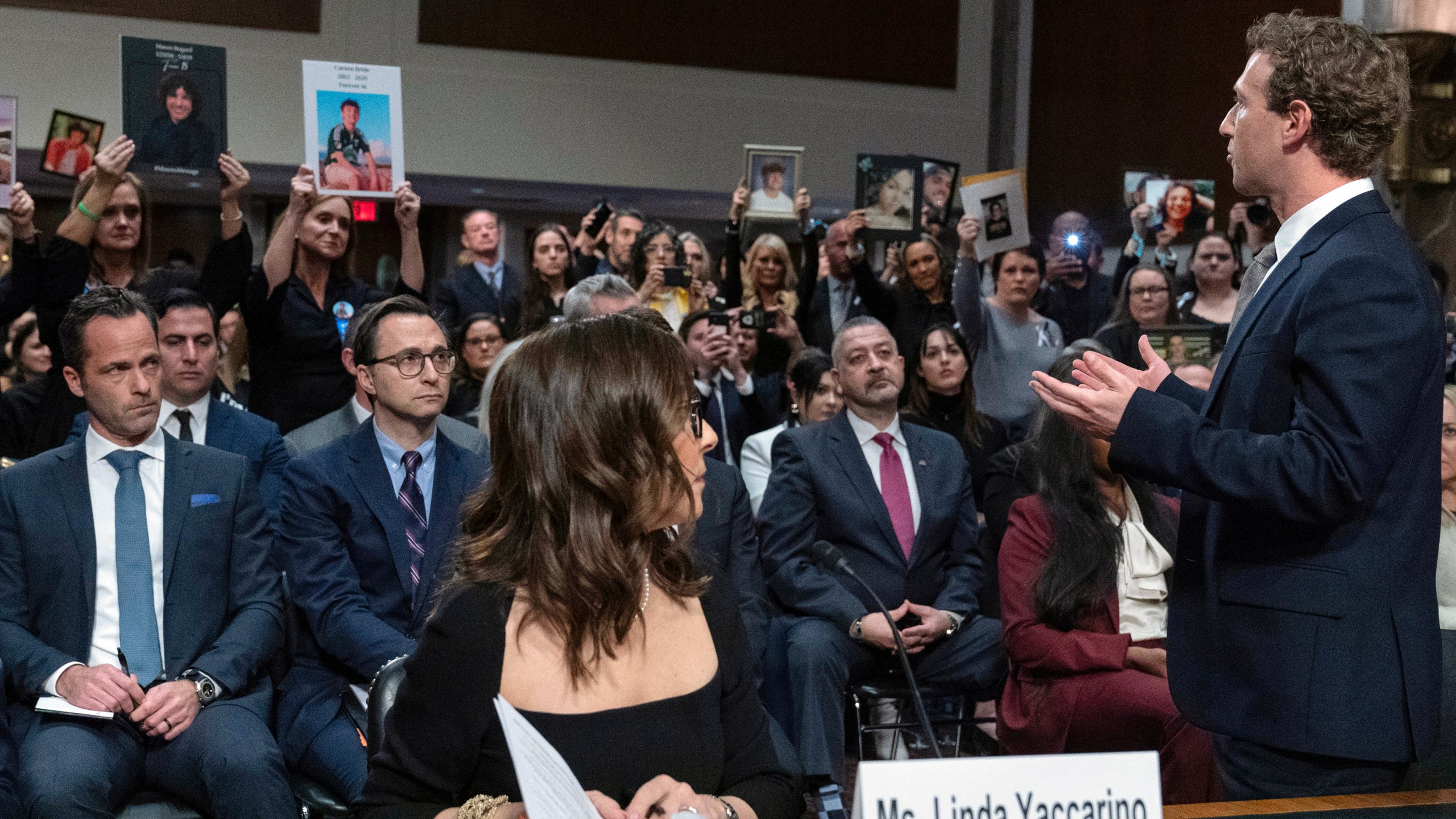 Meta CEO Mark Zuckerberg turns to address the audience during a Senate Judiciary Committee hearing on Capitol Hill in Washington, Wednesday, Jan. 31, 2024, to discuss child safety. X CEO Linda Yaccarino watches at left. (AP Photo/Jose Luis Magana)