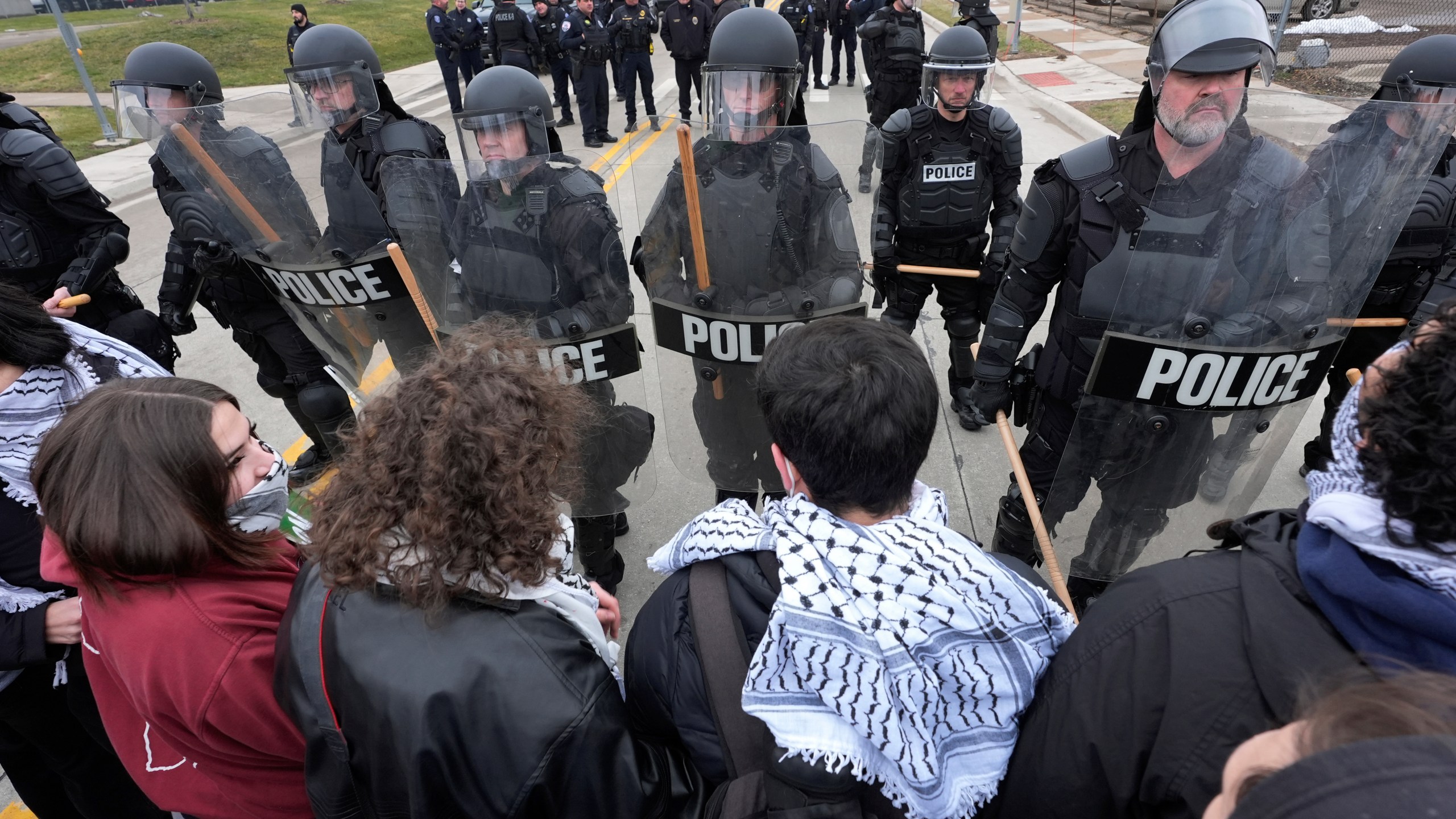 Pro-Palestinian demonstrators march against police during a visit by President Joe Biden in Warren, Mich., Thursday, Feb. 1, 2024. (AP Photo/Paul Sancya)