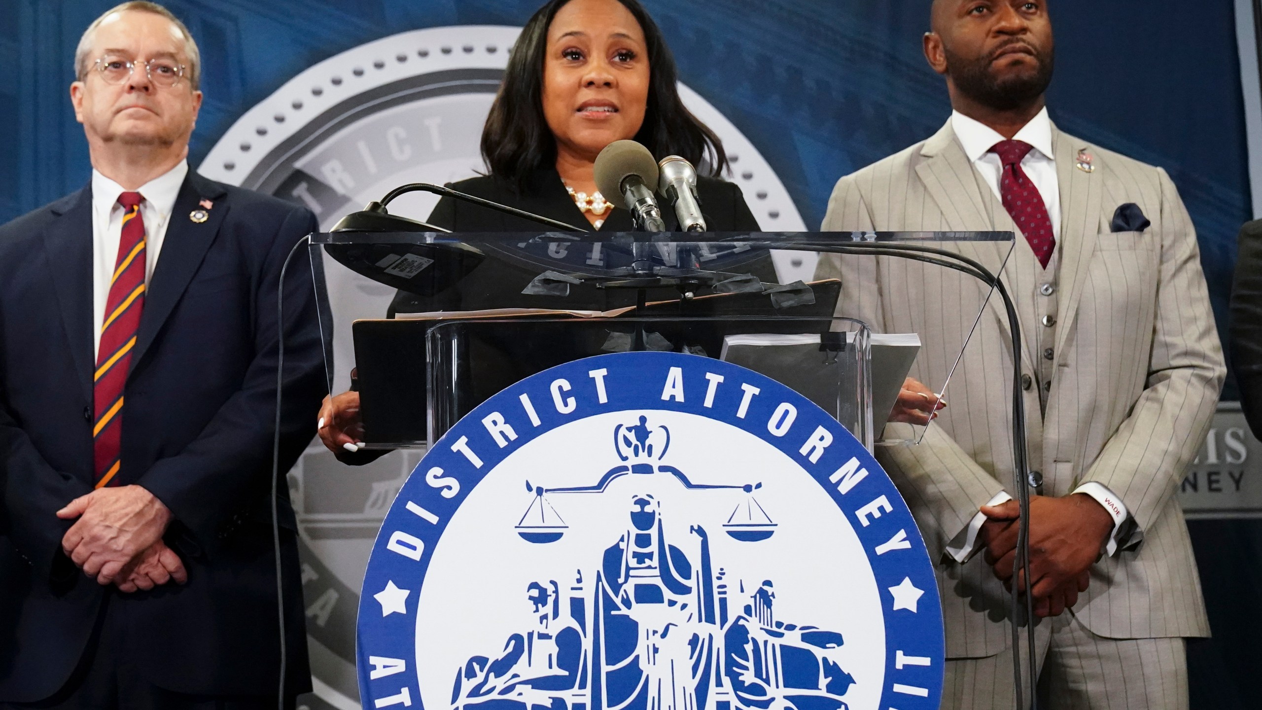 FILE - Fulton County District Attorney Fani Willis, center, speaks along side special prosecutor Nathan Wade, right, during a news conference at the Fulton County Government Center, Monday, Aug. 14, 2023, in Atlanta. Willis acknowledged in a court filing on Friday, Feb. 2, 2024, having a “personal relationship” with Wade, a special prosecutor she hired for the Georgia election interference case against former President Donald Trump, but argued there are no grounds to dismiss the case or to remove her from the prosecution. (AP Photo/John Bazemore, File)