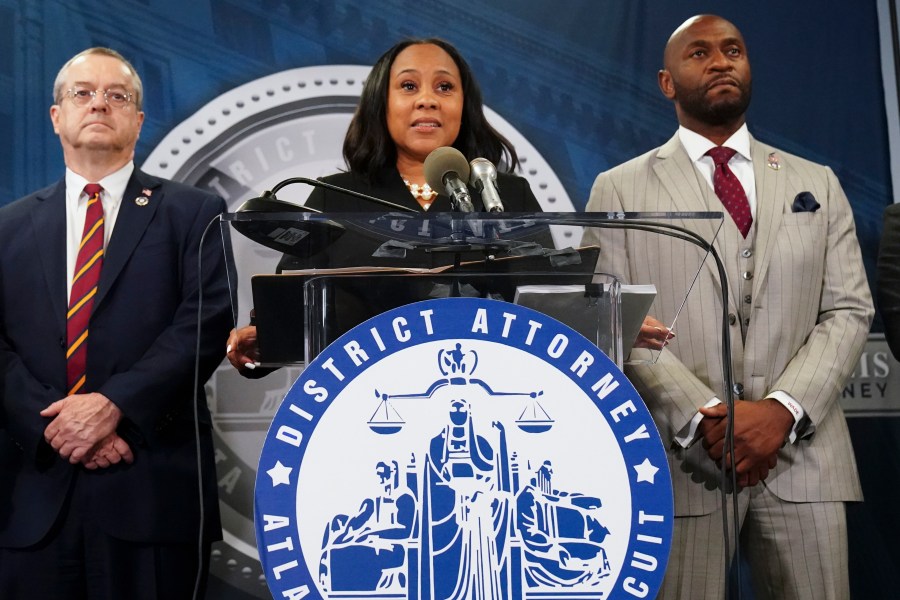 FILE - Fulton County District Attorney Fani Willis, center, speaks along side special prosecutor Nathan Wade, right, during a news conference at the Fulton County Government Center, Monday, Aug. 14, 2023, in Atlanta. Willis acknowledged in a court filing on Friday, Feb. 2, 2024, having a “personal relationship” with Wade, a special prosecutor she hired for the Georgia election interference case against former President Donald Trump, but argued there are no grounds to dismiss the case or to remove her from the prosecution. (AP Photo/John Bazemore, File)