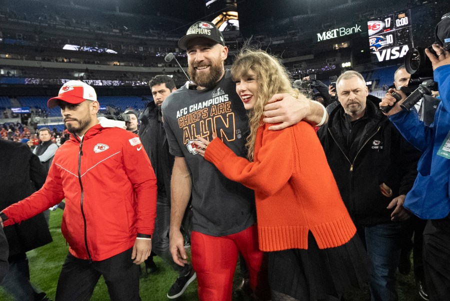 FILE - Kansas City Chiefs tight end Travis Kelce and Taylor Swift walk together after an AFC Championship NFL football game between the Chiefs and the Baltimore Ravens, Jan. 28, 2024, in Baltimore.. Taylor Swift, who is holding concerts in Japan, will make it in time for the Super Bowl to see her partner and football superstar Travis Kelce play. (AP Photo/Julio Cortez, File)