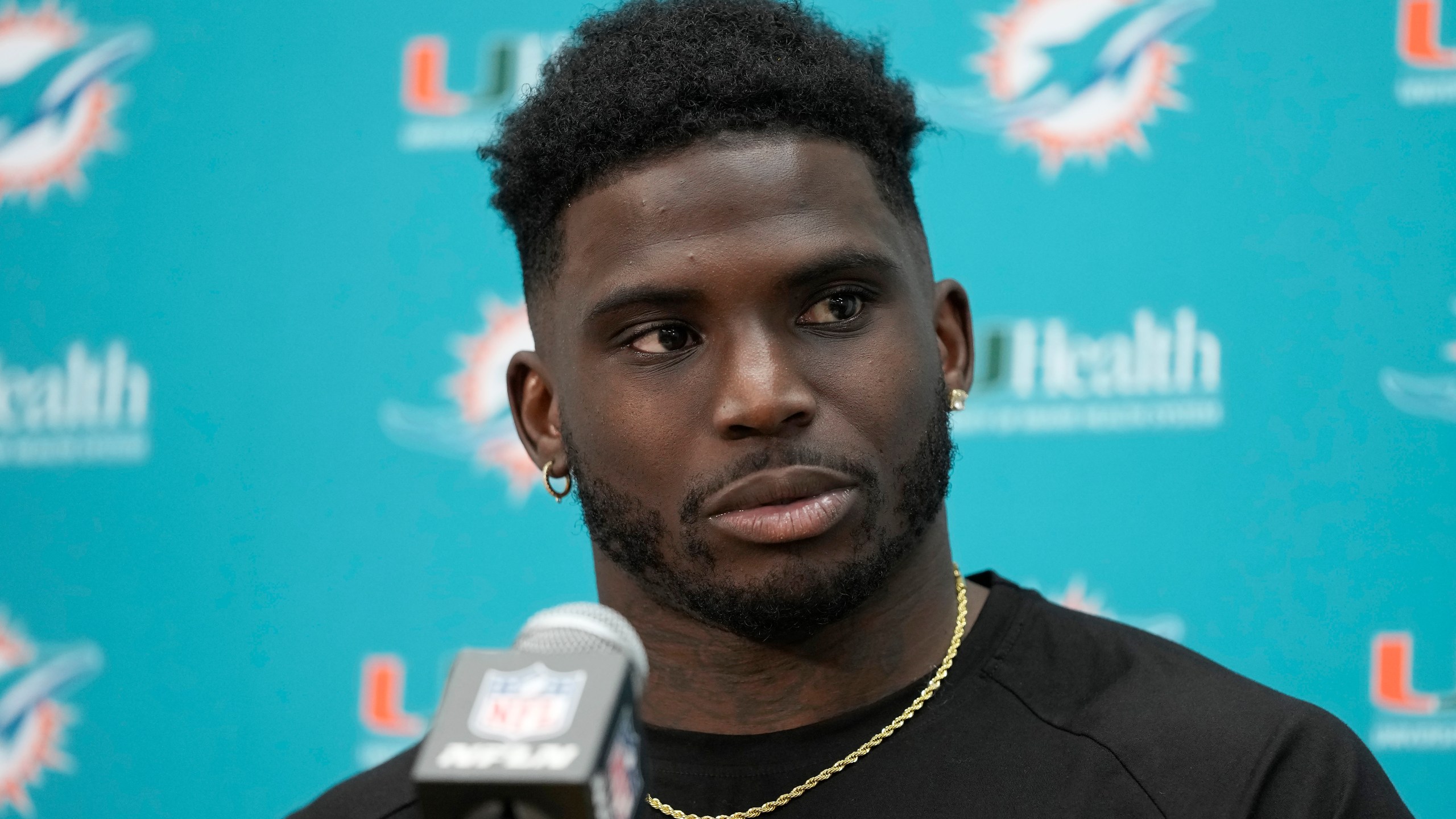 Miami Dolphins wide receiver Tyreek Hill speaks to reporters after an NFL football game.