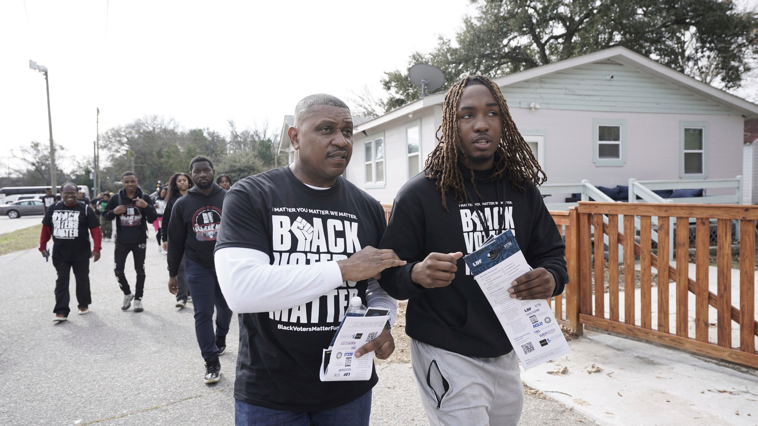 Artie Armstrong, left, and Joshua Rasheed canvas the Liberty Hill neighborhood along with other We Fight Back campaign activists, to encourage residents to vote in elections, on Saturday, Jan. 27, 2024, in North Charleston, South Carolina. (AP Photo/Serkan Gurbuz)