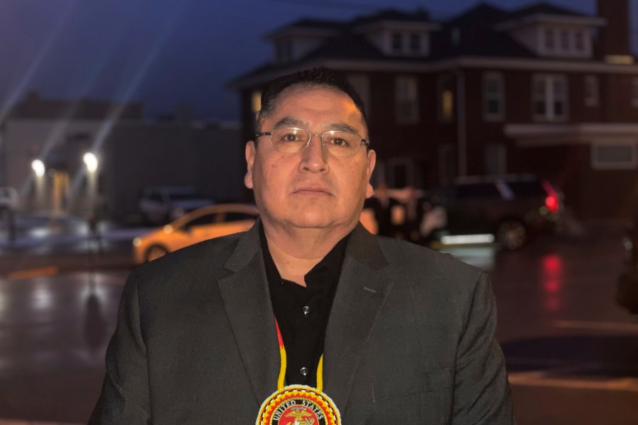 FILE - Oglala Sioux Tribe President Frank Star Comes Out stands outside the Andrew W. Bogue Federal Building and U.S. Courthouse in Rapid City, S.D., Feb. 8, 2023. The South Dakota tribe has banned Republican Gov. Kristi Noem from the Pine Ridge Reservation after she spoke this week about wanting to send razor wire and security personnel to Texas to help deter immigration at the U.S.-Mexico border and also said cartels are infiltrating the state's reservations. (Kalle Benallie/Indian Country Today via AP, File)